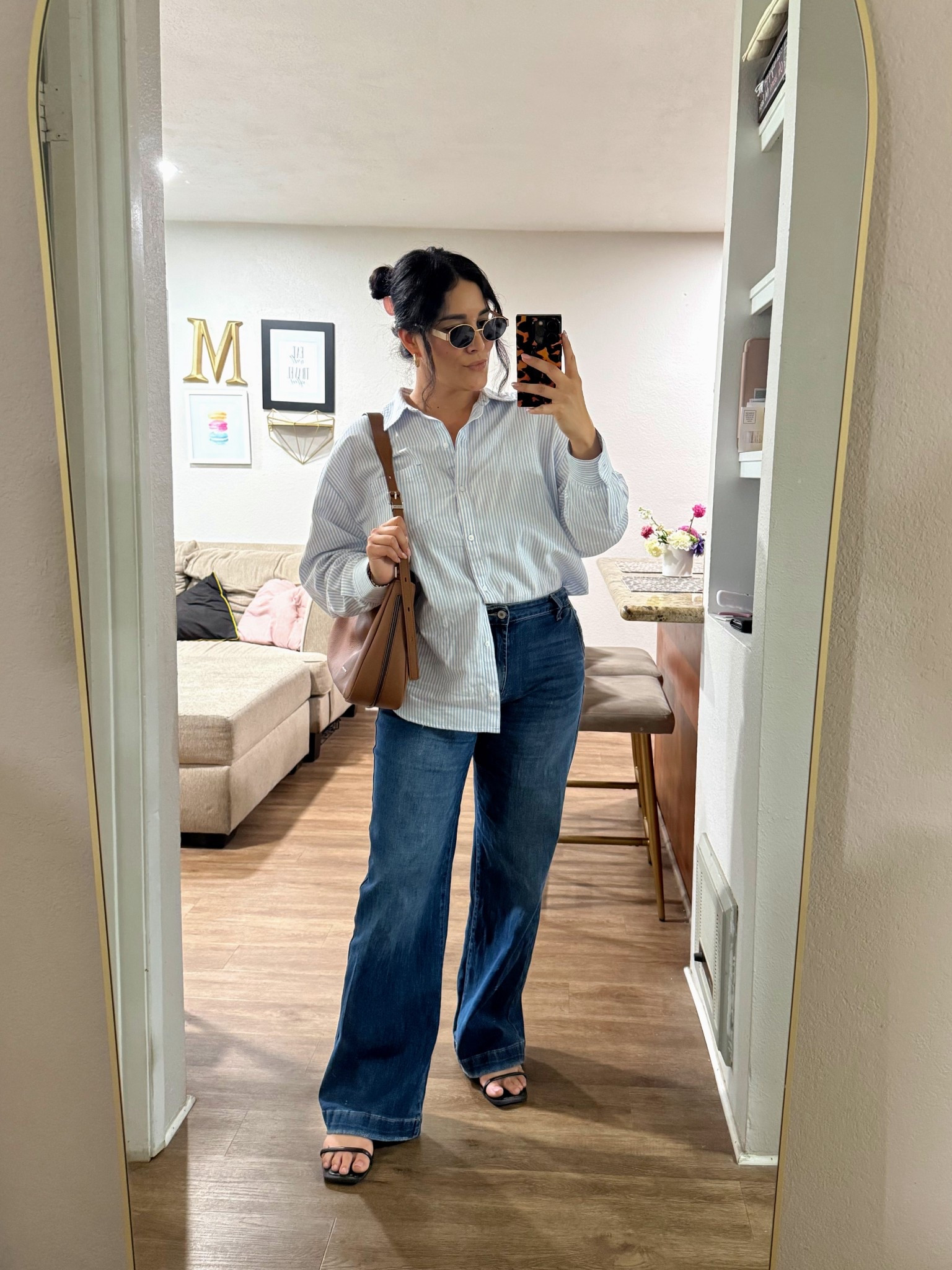 Blue striped button down with wide leg jeans is one of those easy outfits that always looks a little elevated without trying too hard. I love how the relaxed fit top balances the denim, and the brown bag plus black sandals keep it feeling polished for everyday errands, lunch, or casual office days 🤍👖👜

Sizing Deets👇🏽
Top // M
Jeans // 10
Sandals // 8

#LTKootd #LTKOver40