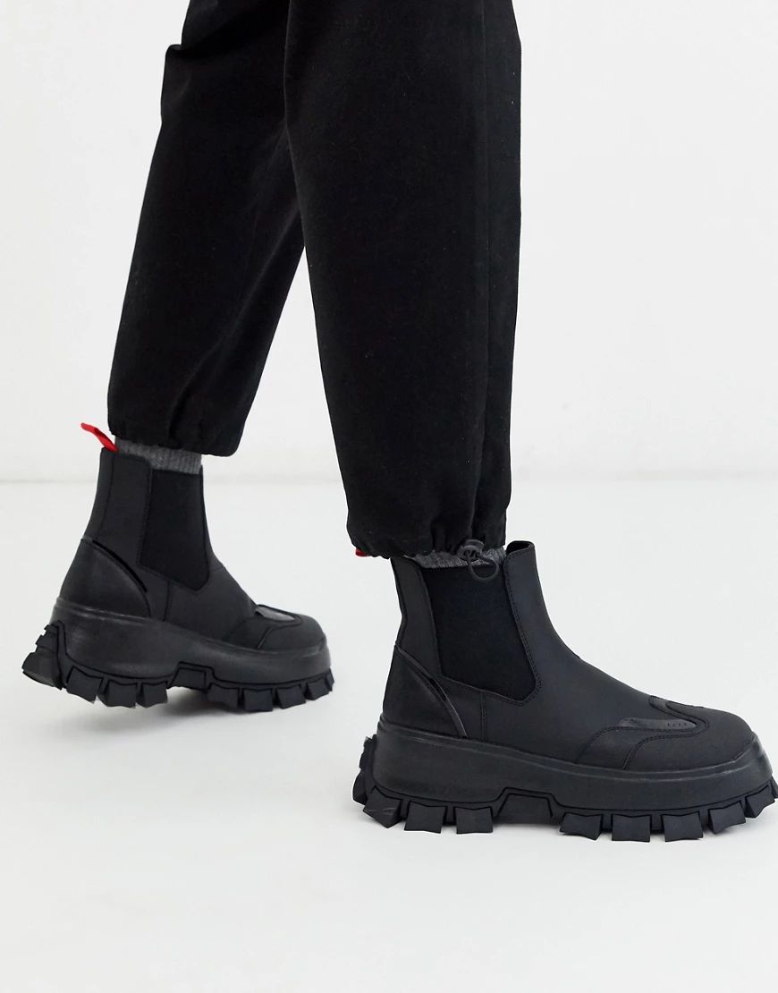 ASOS DESIGN chelsea boots in black with strapping details and chunky cleated sole | ASOS (Global)