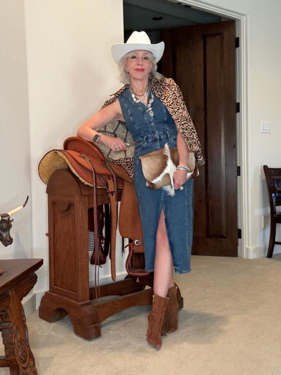 Denim midi dress
Springbok clutch bag
Suede booties 
Silver southwest necklace and earrings 
Leopard print jacket
White felt cowboy hat

#LTKOver40 #LTKItBag #LTKStyleTip