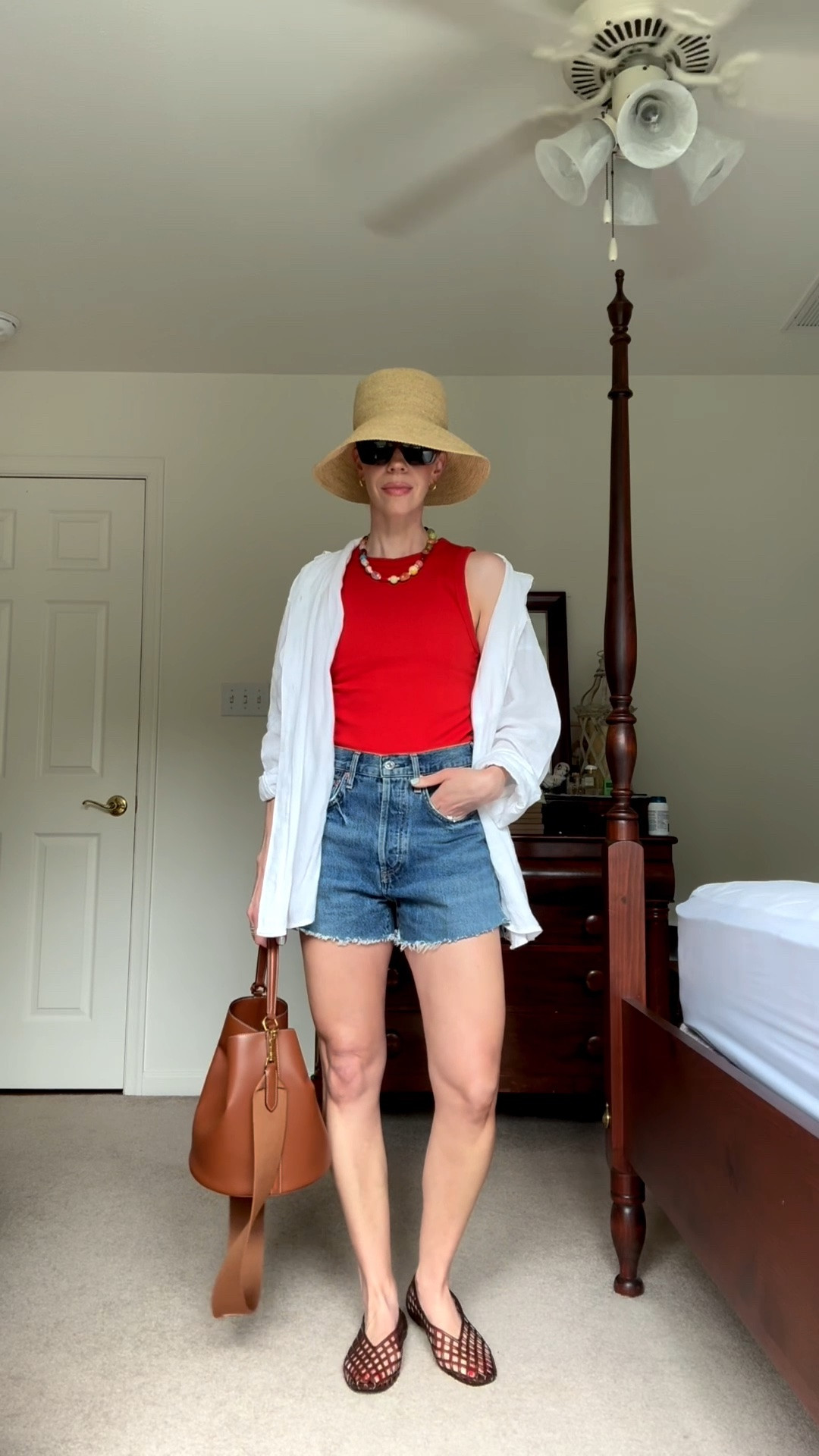 Casual summer outfit with red tank top, denim cutoff shorts, jelly shoes, @Janessa Leone straw bucket hat, beaded necklace

#LTKSeasonal #LTKOver40 #LTKgrwm
