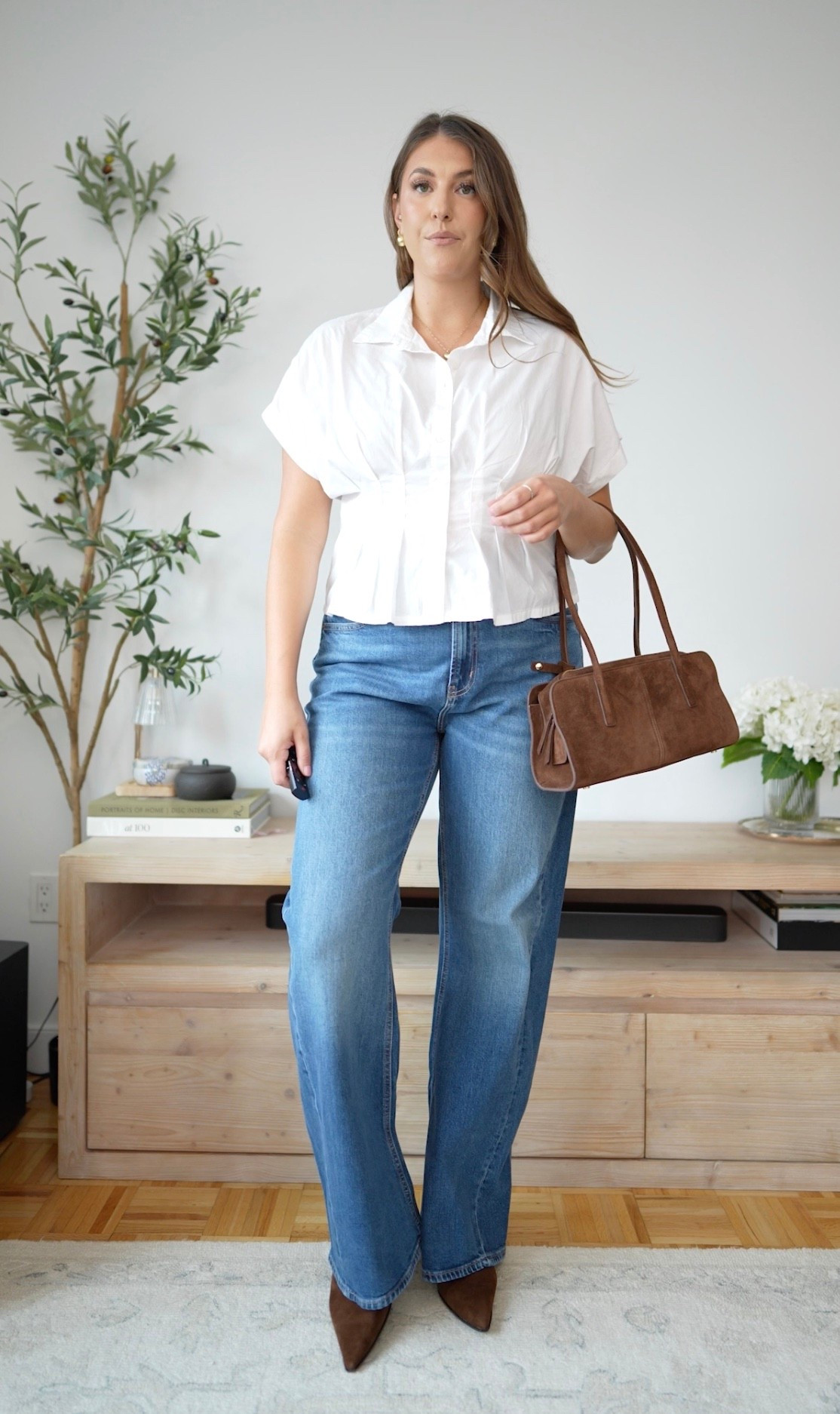 The kind of outfit I’ll be repeating all fall 🤎 Crisp white top, relaxed denim, chocolate suede accessories, and the perfect mix of polished and effortless.

fall outfit inspiration, casual fall style, wide leg jeans, white blouse outfit, suede bag, brown heels, everyday style, elevated casual. Size large, size 14 | runs tts

#LTKootd #LTKSeasonal #LTKMidsize