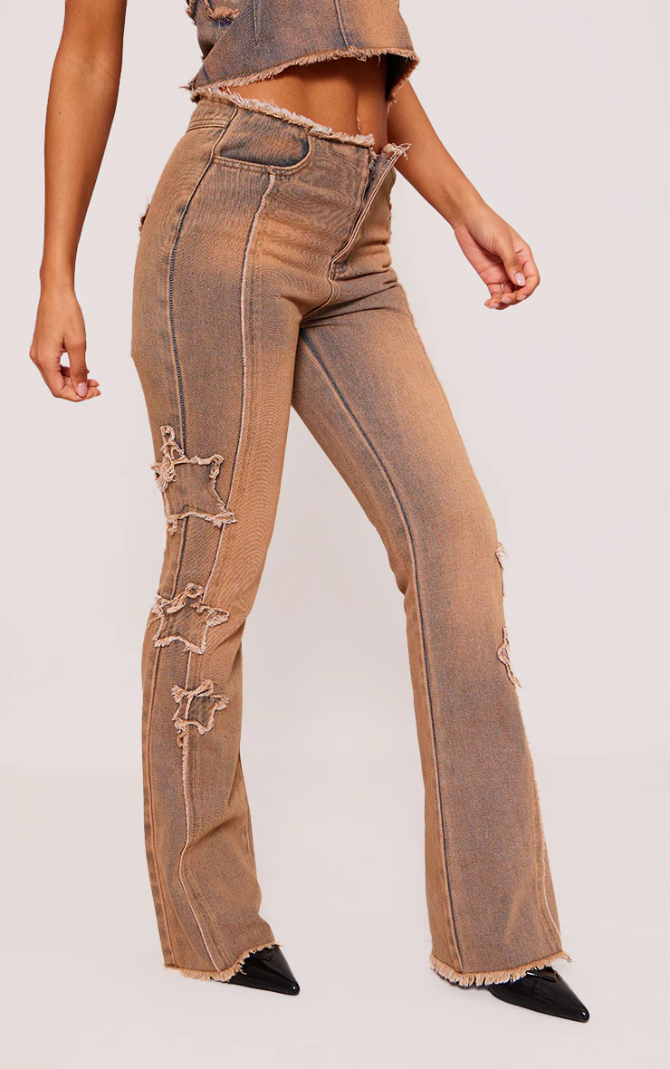 Vintage Wash Orange Tint Raw Hem Star Embroidery Flared Jeans | PrettyLittleThing UK