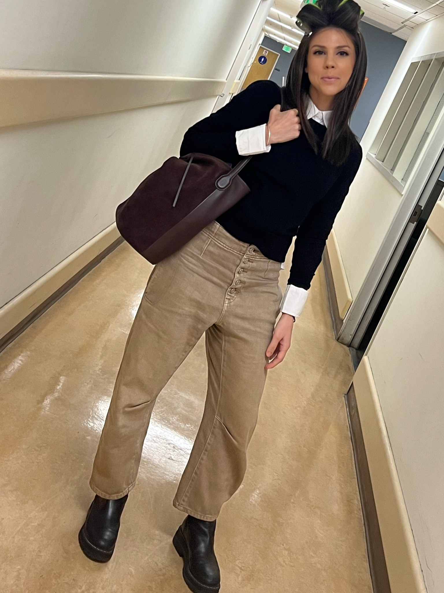 White button up • black sweater • tan mid rise barrel jeans • black lugsole boots • brown bucket bag 