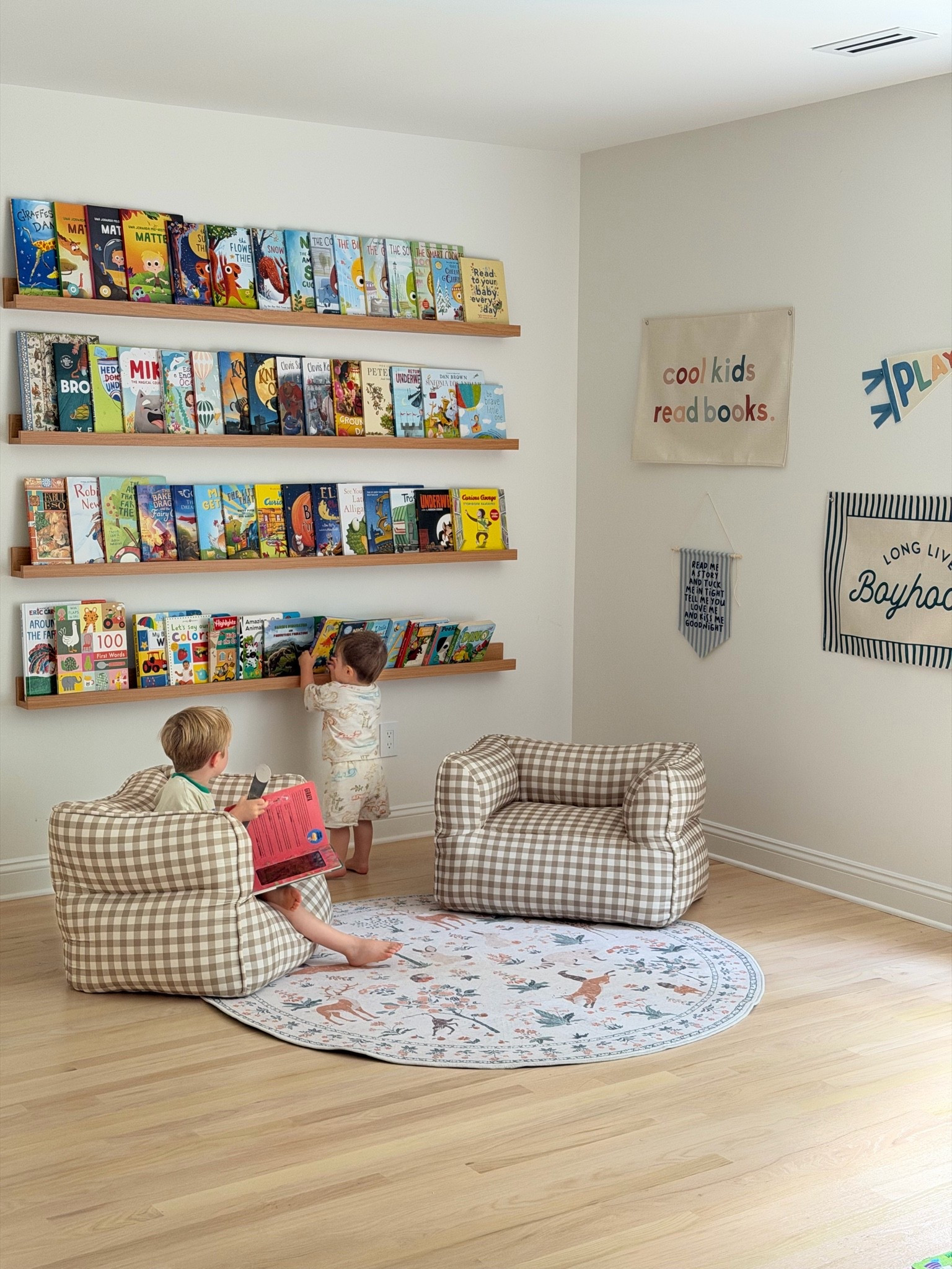 The cutest reading corner for our boys!! Obsessed with these comfy gingham reading chairs, and this rug is SO soft and affordable. Linked everything we used!