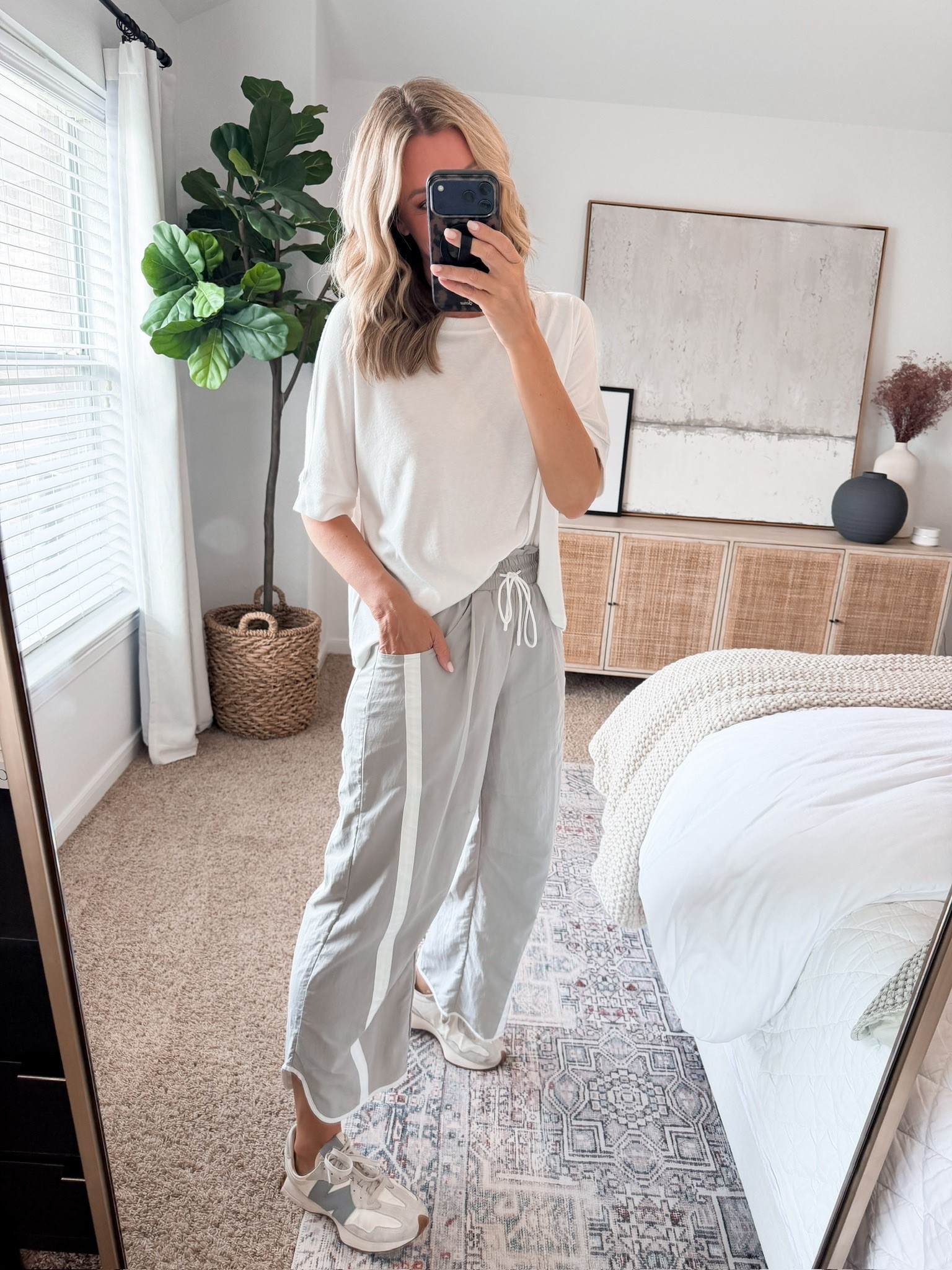 Track pants, but make them everyday. I love the relaxed wide leg shape and contrast stripe with a simple white tee and sneakers. Comfortable enough for a busy day without looking like you just left the gym.

wide leg track pants, striped track pants, casual fall outfit, white tee outfit, sporty fall style, athleisure outfit, sneaker outfit, relaxed pants, everyday fall outfit, transitional fall style, comfortable fall outfit, HauteandHumid

#LTKootd #LTKSeasonal #LTKOver40