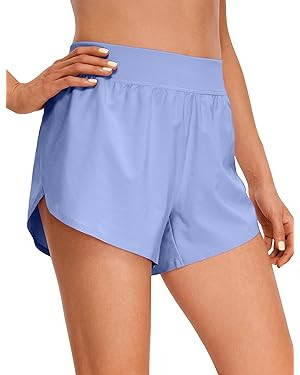 CRZ YOGA Mid Waisted Dolphin Athletic Shorts for Women Lightweight High Split Gym Workout Shorts ... | Amazon (US)