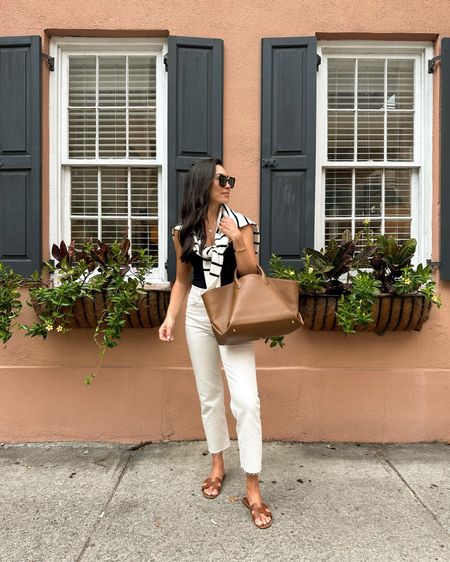 Kat Jamieson wears an easy everyday outfit in Charleston. Cream jeans, denim, Hermes Oran sandals, Khaite tote bag, leather tote, purse, classic style, stripe sweater, bodysuit. 

#LTKworkwear #LTKSeasonal #LTKitbag