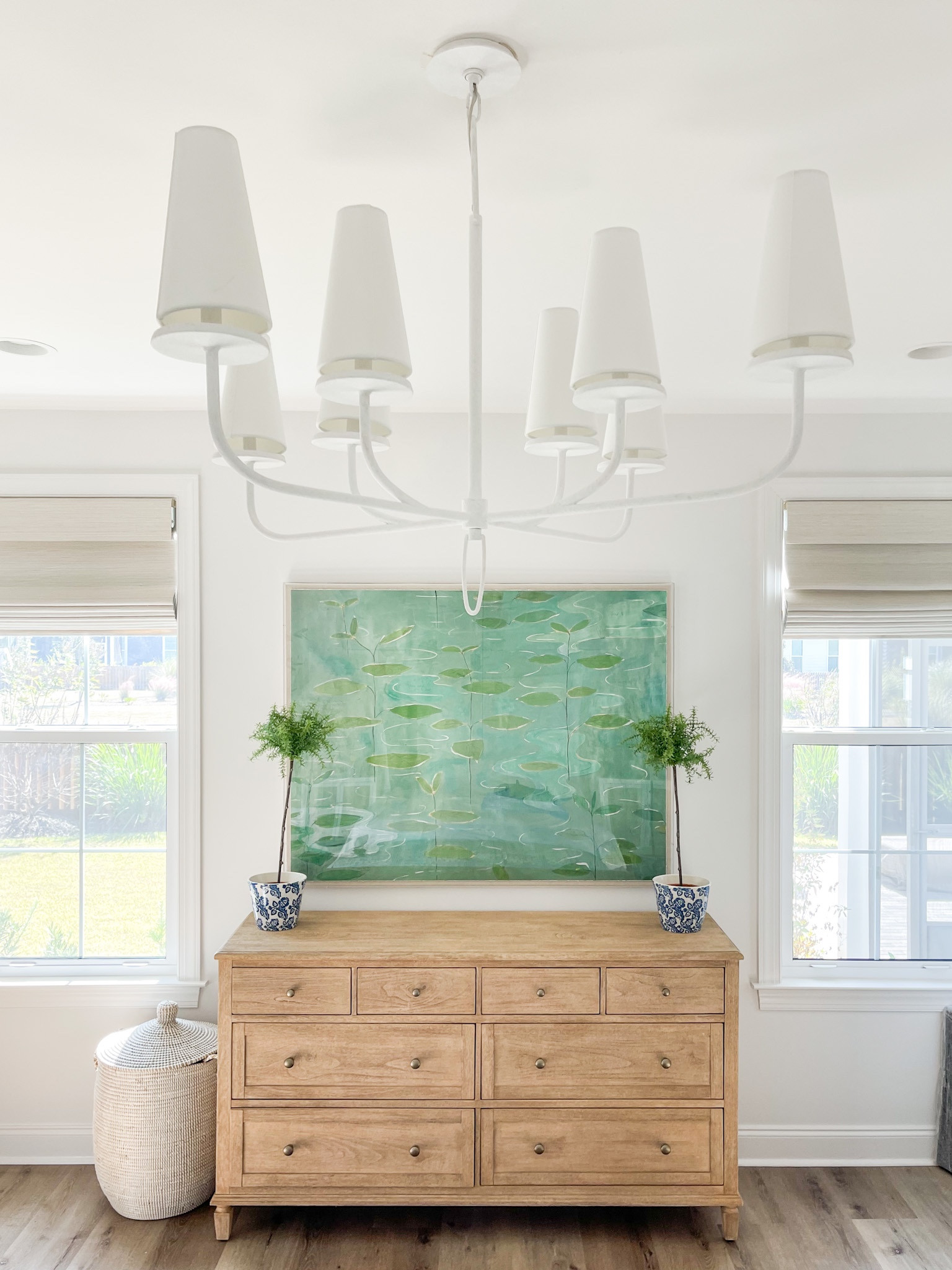 Loving how our primary bedroom is coming together in Florida! We’re using our light wood dresser that we’ve loved for years, but added this new gesso white chandelier, lily pad art, and woven basket hamper. Also linking our white upholstered bed, batik bench, rattan nightstands and blue gray lamps. 

. coastal master bedroom, green and blue bedroom decor, dresser styling ideas

#ltkhome #ltksalealert #ltkunder100 #ltkunder50 #ltkstyletip #ltkseasonal #ltkfamily 

#LTKunder100 #LTKhome #LTKsalealert #LTKhome #LTKsalealert #LTKSeasonal