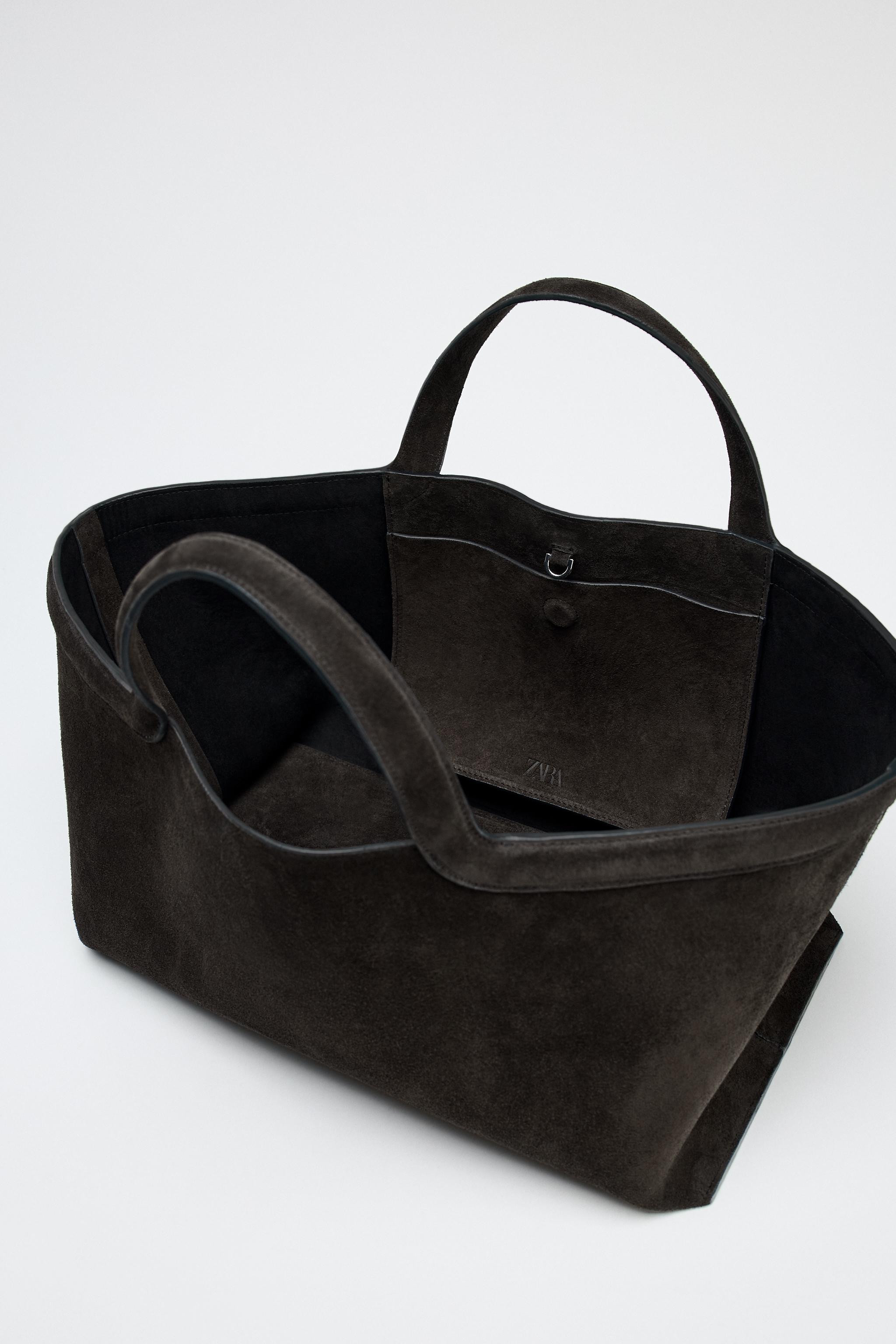 Elongated suede tote bag. Top handle. Inside pocket with magnetic clasp fastening. Buckle closure... | Zara UK