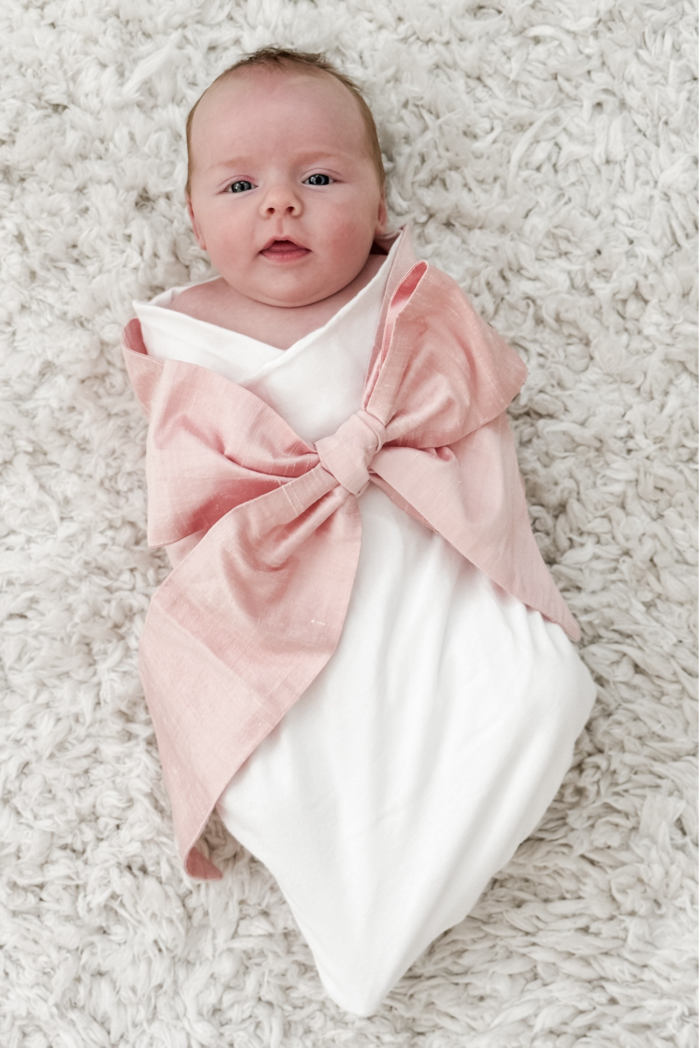I almost forgot to capture this little bean in our little heirloom bow swaddle before she outgrows it! 💕🎀 Such a sweet way to wrap your babe and it’s especially perfect for newborn photos. There are many different ribbon shades and a few ribbon fabrics to choose from (plus, they’re monogrammable!) — we have the “Southern Blush Silk” option. 

#LTKBaby #LTKBump