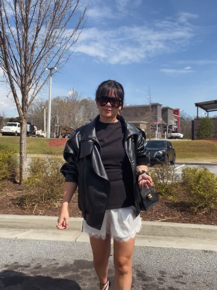 78° out in the middle of March with a small touch of pollen. I really enjoy this weather. I get to wear satin lace-trimmed shorts and open-toe sandals. I just have to throw on an oversized leather jacket because it gets cold in rooms with AC, and I’m always cold. 
Check out outfit details in my LTK shop. Link is in bio 🔗