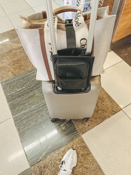 Love this Amazon travel find. It slips over your carry on luggage handle and then has a strap to secure your bag to your suitcase for easy maneuvering through airport  

#LTKtravel #LTKFind #LTKunder50