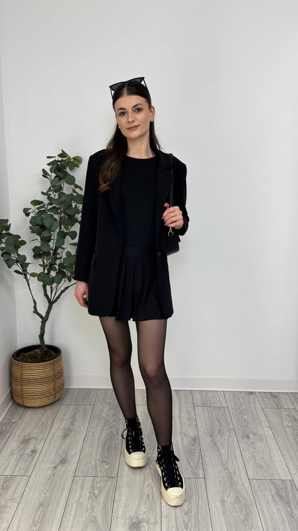 A sleek all-black ensemble featuring a pleated mini skirt, fitted top, and structured blazer. Sheer tights add elegance, while high-top Converse bring a casual contrast 🖤 #IlaStylesDiary 

#LTKeurope #LTKspring #LTKworkwear