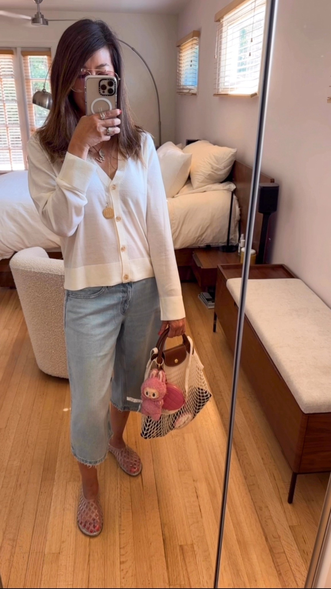 Summer OOTD 💁🏻‍♀️☀️
Capris are having a moment and I’m fully here for it! 🙌🏼 Threw on the easiest jelly slides (comfy and cute), a light summer sweater over a basic tank (always layering because AC = 🥶), and of course, my mesh Longchamp, fully decked out with Labubu + my fave charm 🐰💗
Pro tip: use a pouch inside or say bye bye to all your tiny catch-alls. Lol. 😂 
Cardigan (size S)
Capri jeans (size 4)
Jelly shoes (size 6.5)

#LTKShoeCrush #LTKStyleTip #LTKItBag