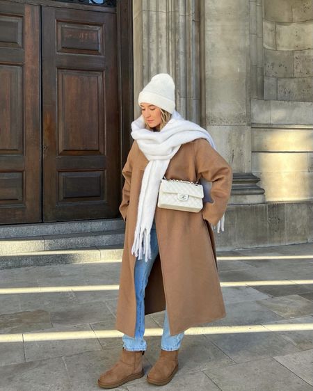 Brown & blue winter outfit with white accents. White Chanel bag, white beanie hat & scarf, camel brown belted coat, blue mom jeans & brown Ugg boots  

#LTKitbag #LTKstyletip #LTKshoecrush