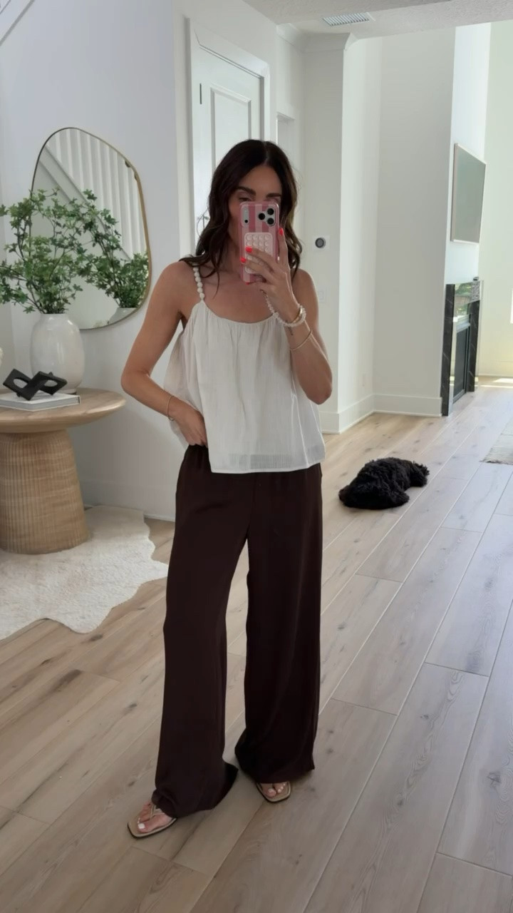 I love this color combination for late summer and early fall. The flowy chocolate brown pants have beautiful movement, and the airy white tank keeps the look light and balanced. It’s an easy outfit that looks elevated with minimal effort.

S bottoms, XS top

brown pants, white tank top, wide leg pants, casual chic outfit, neutral outfit, transitional style, late summer outfit, everyday fashion, vacation outfit, effortless style, annabrstyle

#LTKootd #LTKSeasonal #LTKTravel