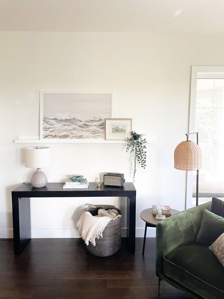 Modern and simple black console  table, rattan floor lamp, oversized rattan basket, cozy velvet armchair. #livingroomdesign #consoletable 

#LTKhome #LTKFind