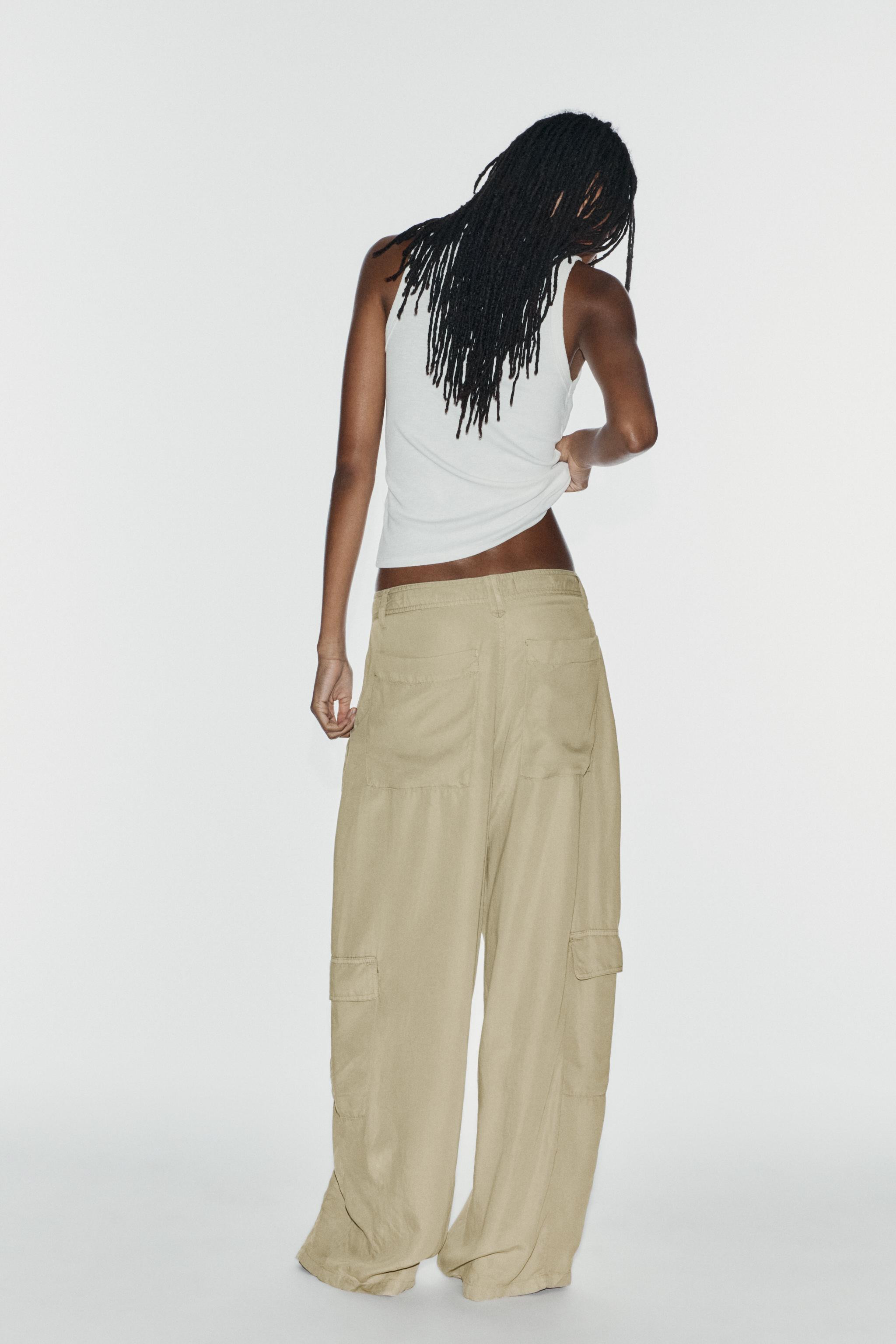 Trousers made from a lyocell blend. Mid-waist design featuring belt loops and adjustable ties. Pa... | Zara UK