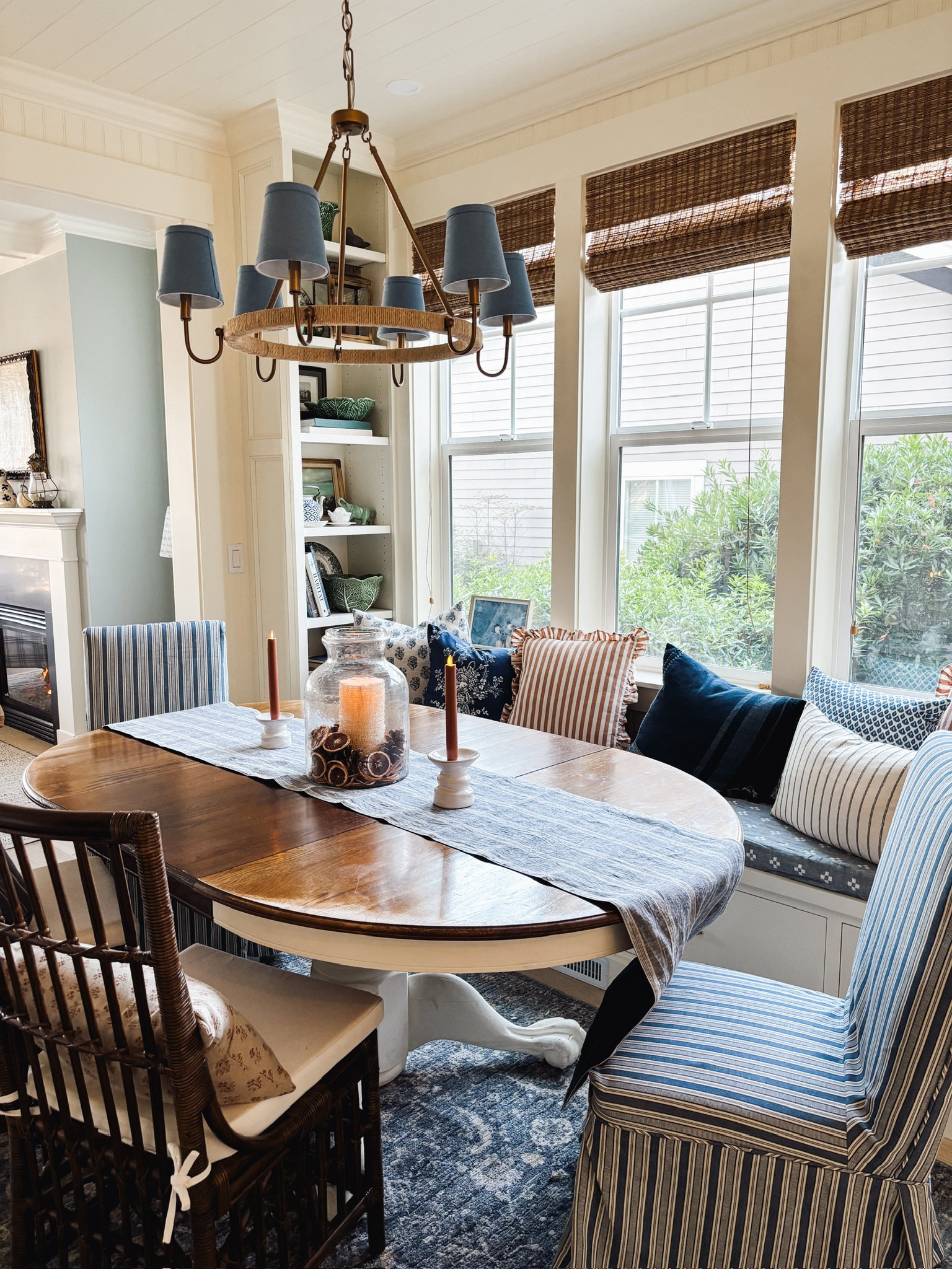 Coastal cottage dining room sources - blue striped slipcovered dining chairs, similar rattan chairs, battery taper candles, striped blue runner, similar bamboo blinds, jute wrapped chandelier with blue shades (more color options available), blue patterned rug

#LTKSeasonal #LTKhome #LTKstyletip
