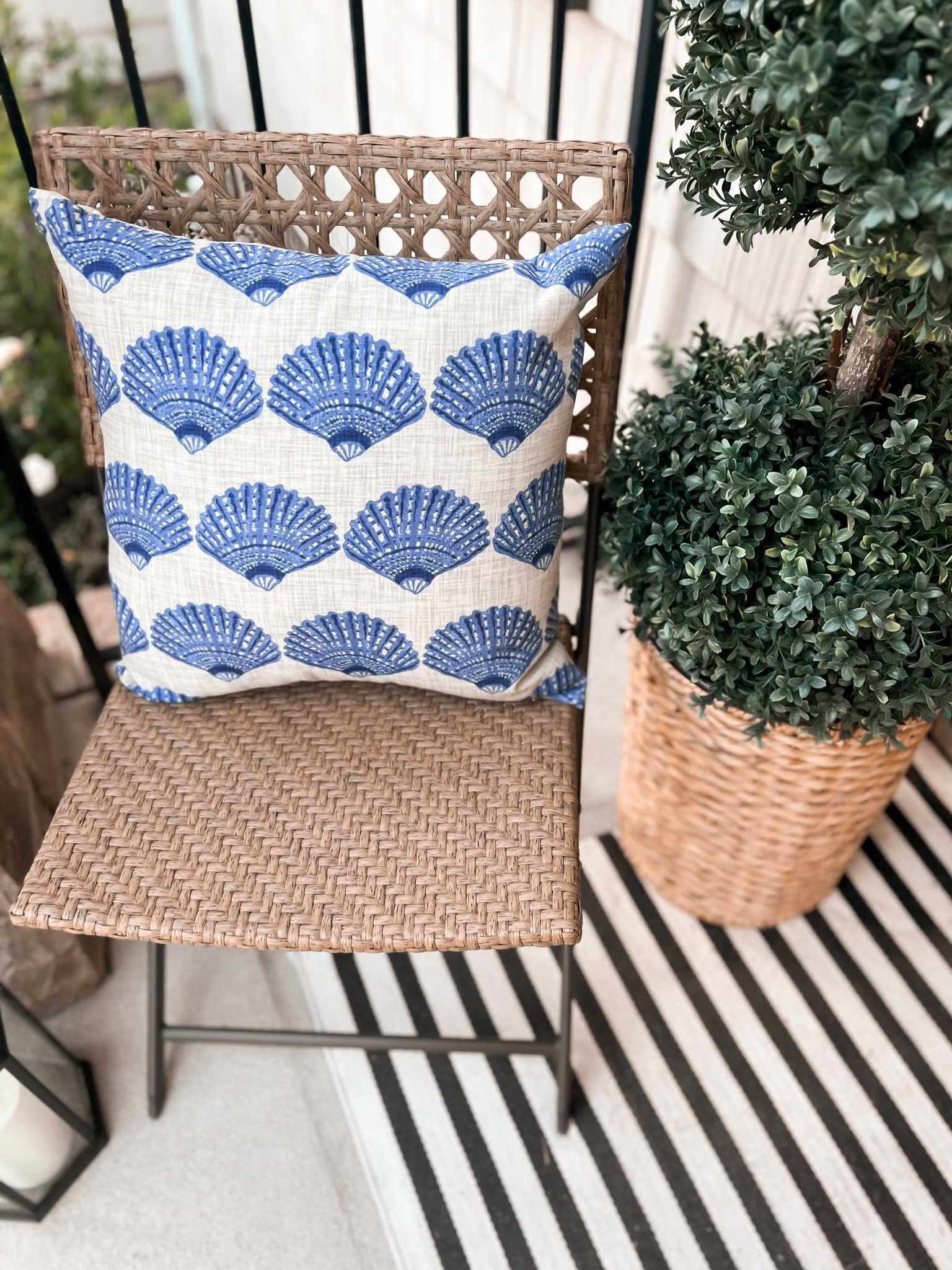 Refreshing front porch makeover with a new outdoor wicker folding chair and blue and white shell pillow. 

#LTKunder100 #LTKSeasonal #LTKhome
