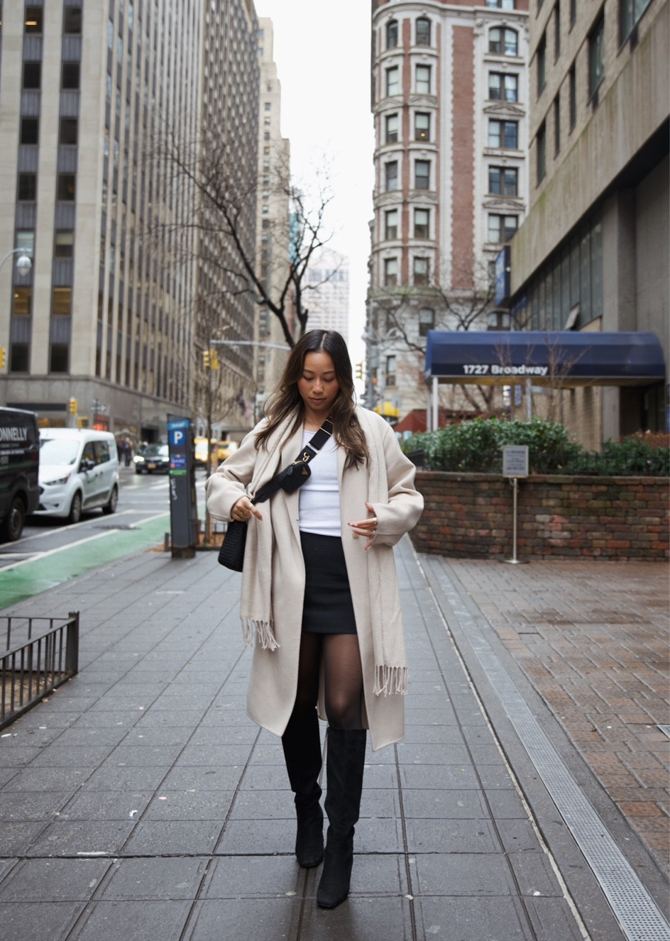 nyc outfit 🫶🏽 | new york city outfit inspo | beige wool coat | long wool coat | long winter coat | black mini skort | black tights | white long sleeve top | winter outfit inspo | neutral outfit inspo | winter fashion | neutral fashion | uniqlo coat | abercrombie skort | amazon fashion tights | neutral winter outfit inspo 

#LTKSeasonal #LTKstyletip #LTKtravel