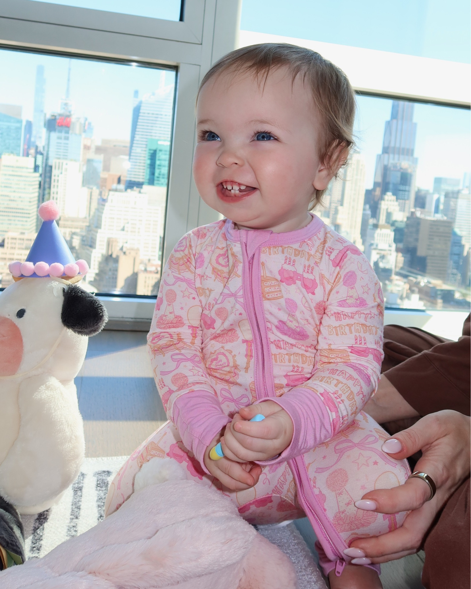 Sutton woke up to a little birthday surprise this morning for her FIRST birthday! 🥹💕

Kay thought ahead and brought some of her stuffed animals with us to NYC, so before she woke up this morning, we tied balloons to them and had them waiting for her. 🥹 We know how much she loves balloons, but I had no idea how she was going to react.

As soon as she saw them she started crawling as fast as she could to get to her animals and the balloons. 😭It was seriously the sweetest thing.

I still can’t believe our little girl is ONE. 🥹🩷 A year ago today we were in the hospital holding her for the first time, and now she’s crawling everywhere, laughing nonstop, playing with her sisters and turning into the funniest little girl. 💕🦕

She was also born on Kay’s late Gigi’s birthday, which makes this day extra special to Kay. 🥹🩷 I think it’s so sweet that they’ll always share October 7th.

Happy FIRST birthday to our sweet Sutton!! 🥹🩷🎂 We love getting to watch you grow and become more YOU every day. We can’t wait to celebrate you even more at your birthday party Saturday!! 🦖🎀🩰