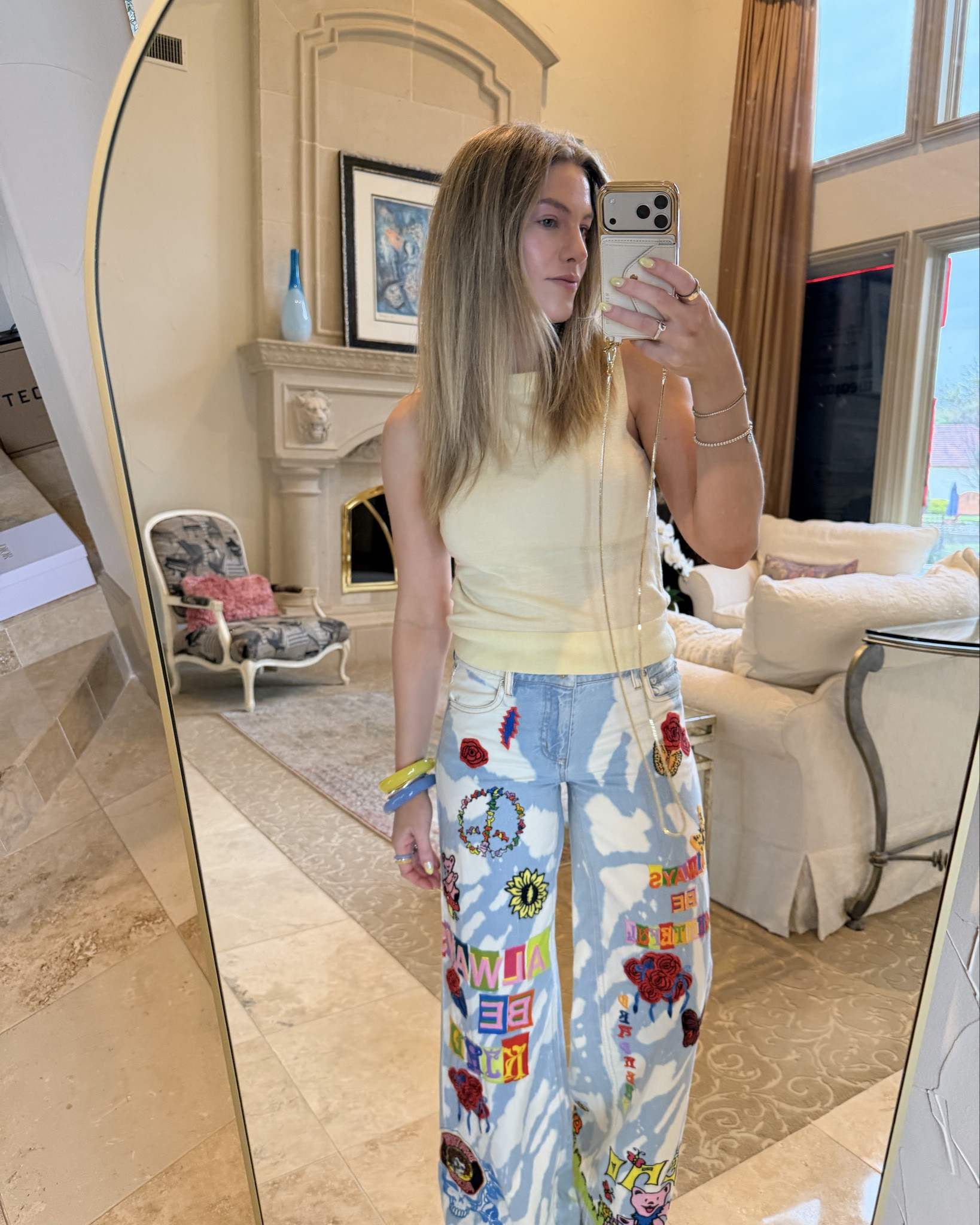 A little OOTD. I’m obsessed with my my new crossbody phone case! Hands-free for errands is a total game charger ✨

@BANDOLIER the remi crossbody phone case 
@Alice + Olivia collab Grateful Dead jeans (size 26) 
@Madewell yellow knit tank top (small), bracelets (one size fits all) & rings (size 9)

#LTKSpringSale #LTKootd #LTKWorkwear