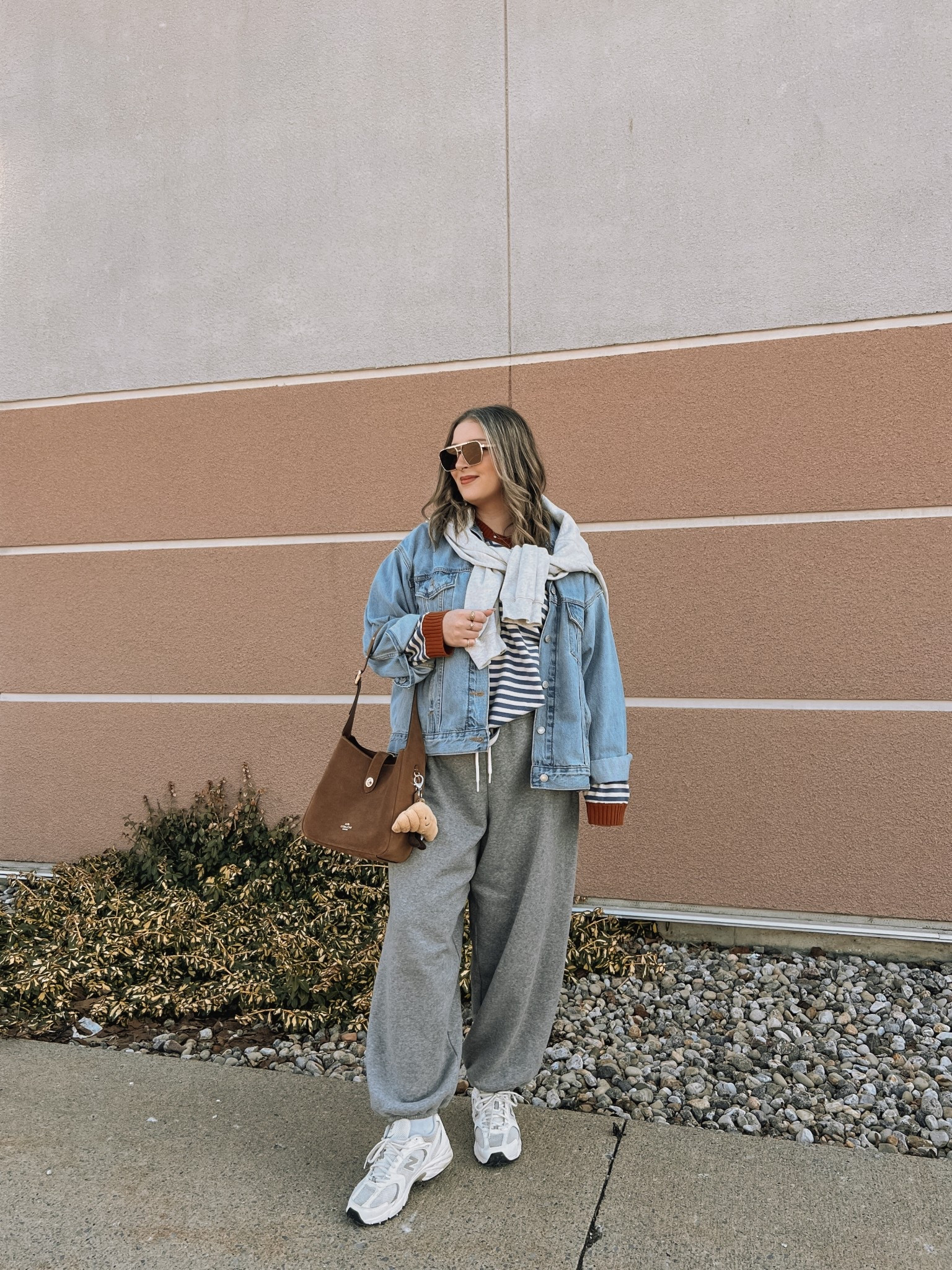 Easy outfit idea for early spring! Wearing my usual size L in the sweatpants and striped sweater - both are so soft! Sized up to XL in the denim jacket for an oversized fit, also linked similar. New Balance sneakers are so comfy for walking but run a little big, I’m a 9.5-10 and wear a 9. 

#LTKsale #LTKstyletip #LTKmidsize