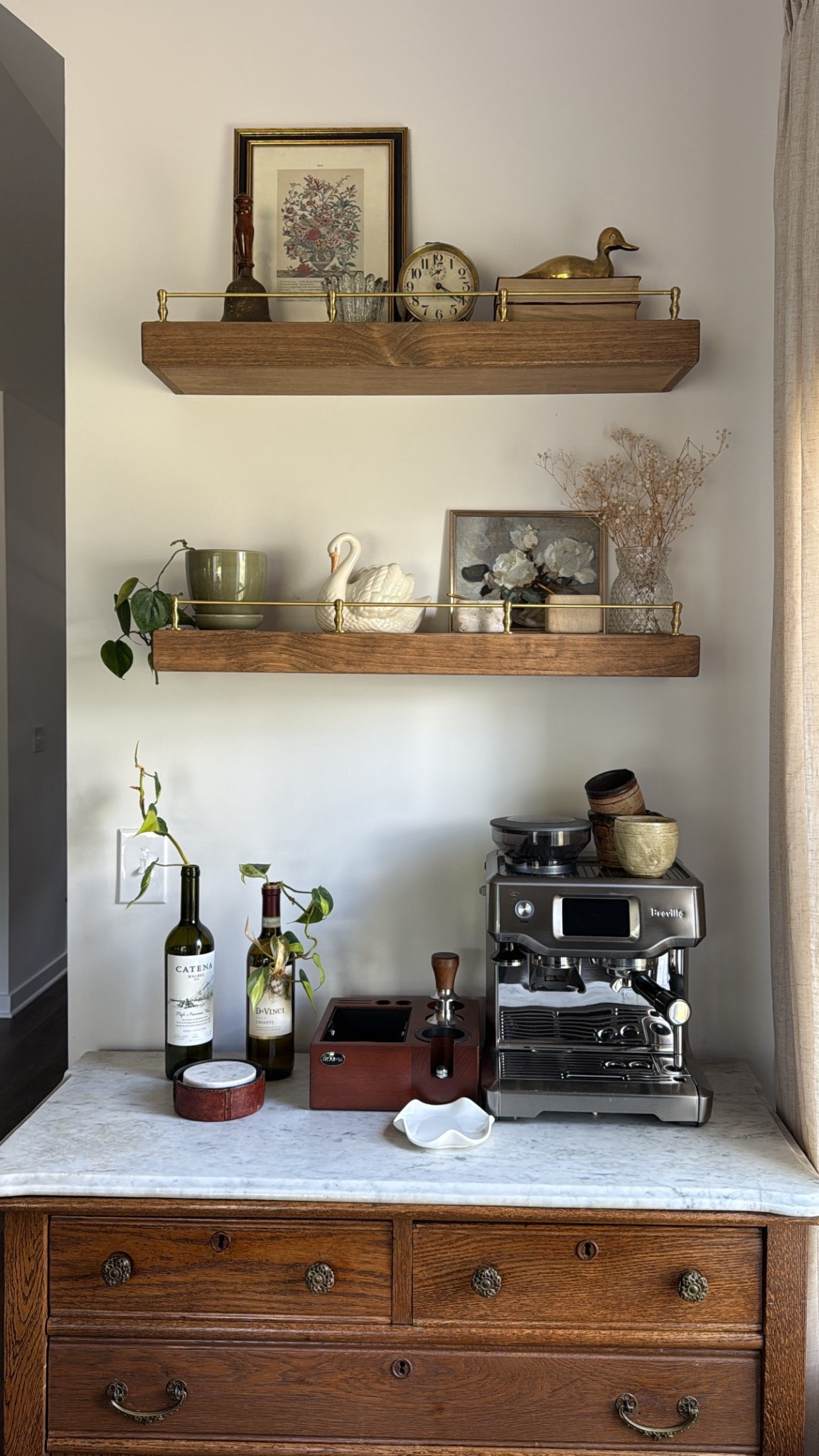 8/27/25 Our cozy at-home coffee bar setup ☕️✨ We used an antique cabinet with a marble slab top and added floating shelves with a gold railing to create this little nook. Linking our Breville Barista Touch and all of my go-to espresso-making details from Amazon so you can recreate the setup at home 🤍

#LTKHome