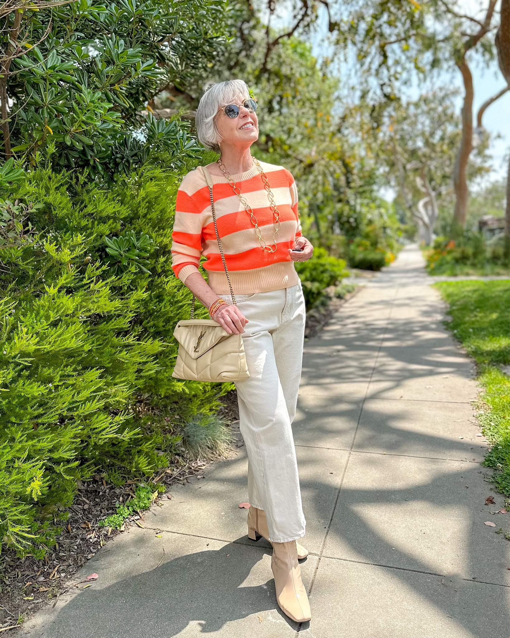 Color crush: the bright hues of this striped sweater 🧡 are an instant mood-lifter! Styled here with ecru boyfriend jeans, a Saint Laurent LouLou puffer bag and vanilla ankle boots  

#LTKitbag #LTKSeasonal