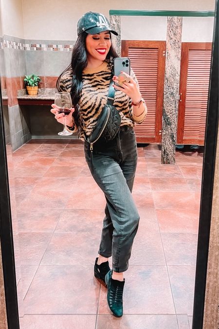 I’m embracing that “mob wife” era! 😜

🖤Outfit Details:
- Animal print sweater originally from H&M in a small.
- High waisted mom jeans in a faded black and tapered at the ankle to roll up and look cute with different shoes.
- Black shooties/boogies.
- Sequin LA Dodger baseball cap.
- Fanny/Waist pack.

#jeans #winteroutfit 

#LTKMostLoved #LTKSeasonal #LTKstyletip