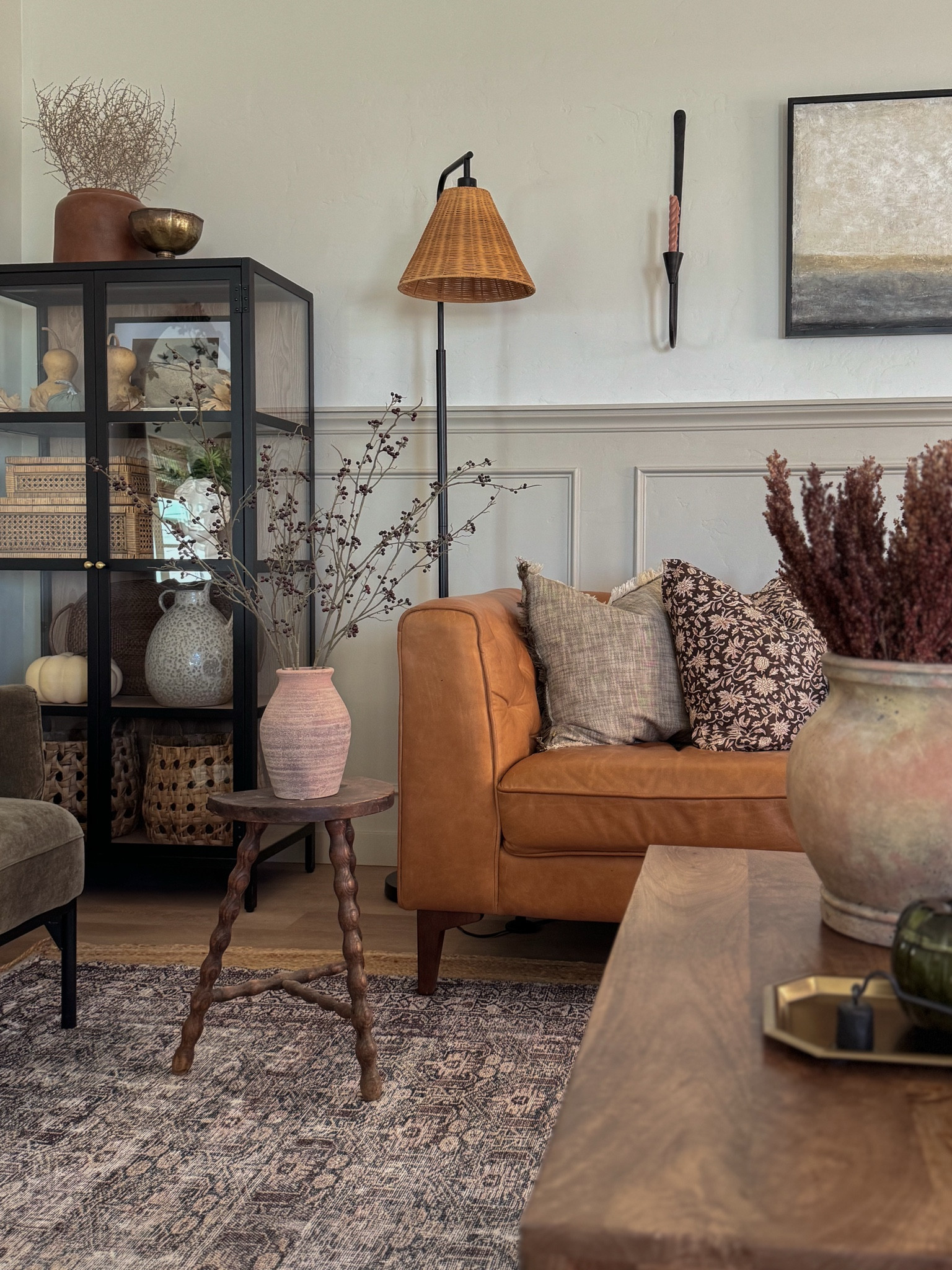 Living room inspo, custom curtains, pinch pleat curtains, floor to ceiling curtains, neutral sofa, beige sofa, west elm penn chair, green accent chair, vintage pillows, Turkish pillows, boucle pillow, shady lady tree, faux tree, greenery, Walmart floor lamp, woven table tray, square wooden coffee table, wall sconce, tapered candle holder, citrus tree, throw pillows, floor length mirror, arch mirror, Target home decor, affordable home, black cabinet, studio McGee cabinet, round glass coffee table, target accent table, vintage inspired rug, vintage milking stool, foot stool
