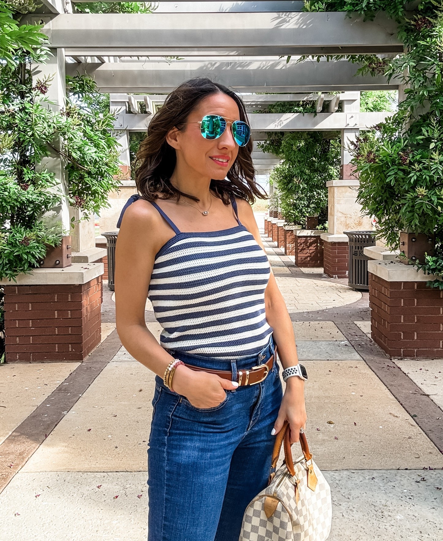 Blue and white stripe knit tank top with tie straps. Runs big. Go down 1 size. 
Levi’s 720 jeans. Run true to size. 
Brown leather belt. 
Neutral Louis Vuitton speedy handbag. 
Petite style 
Lunch style

#LTKOver40 #LTKPetite #LTKootd