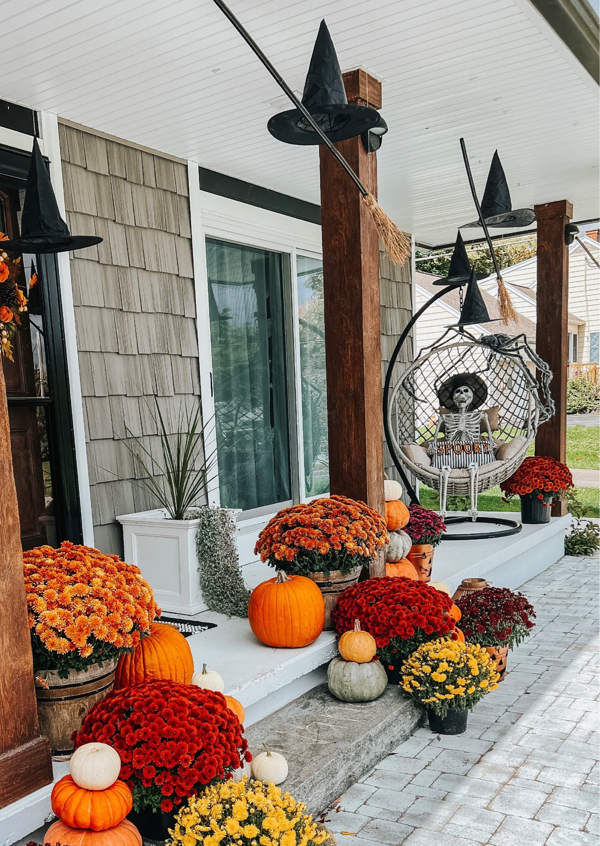 Halloween front porch decor! 

Hanging broomsticks / hanging witch hats / mums / fall decor / fall porch decor 

#LTKstyletip #LTKhome #LTKSeasonal