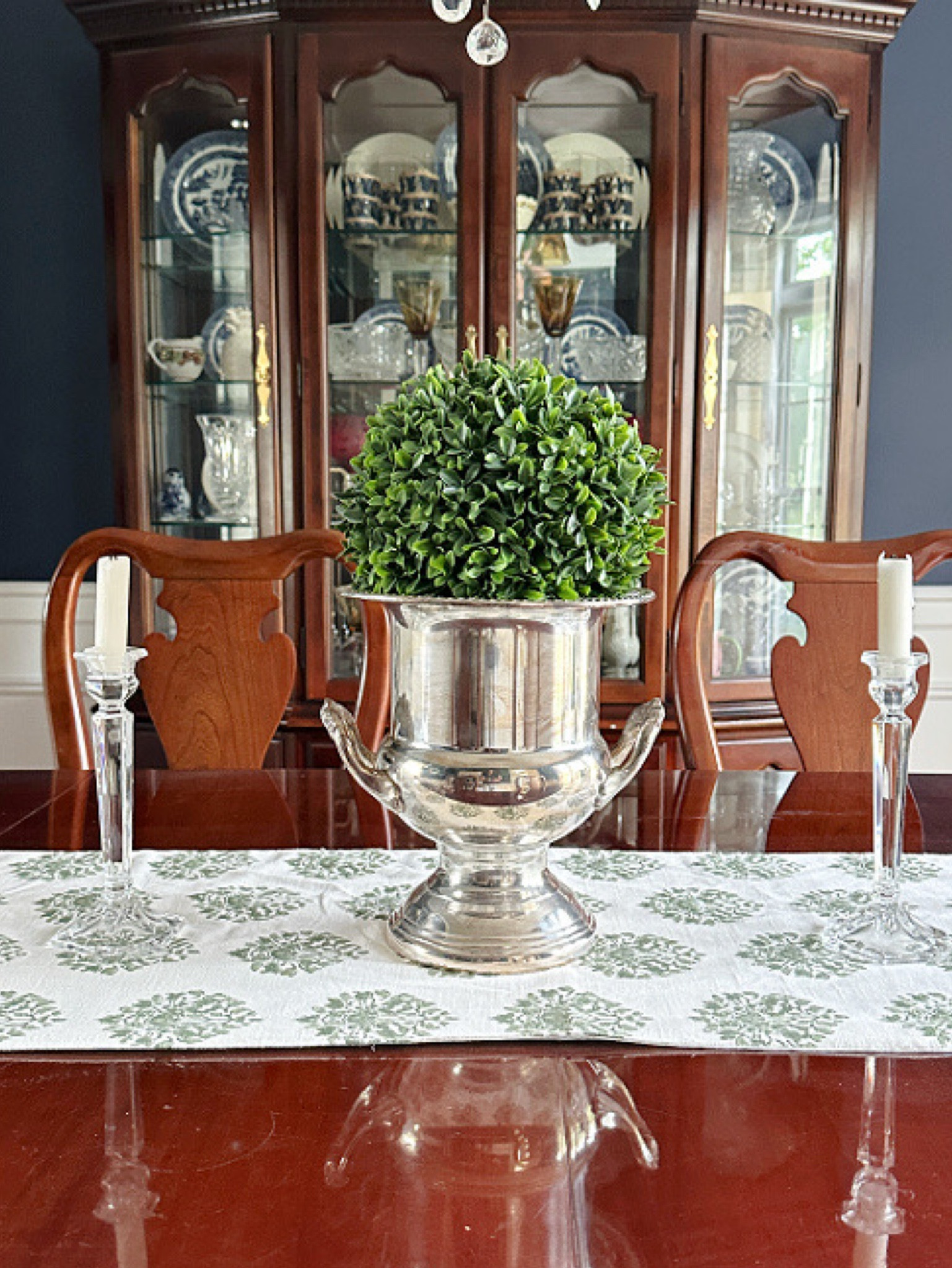 Classic spring and summer styling in the dining room.  Boxwood sphere set in silver urn champagne bucket on a block print table runner.  Get the look...

#LTKmomlife #LTKSeasonal #LTKHome