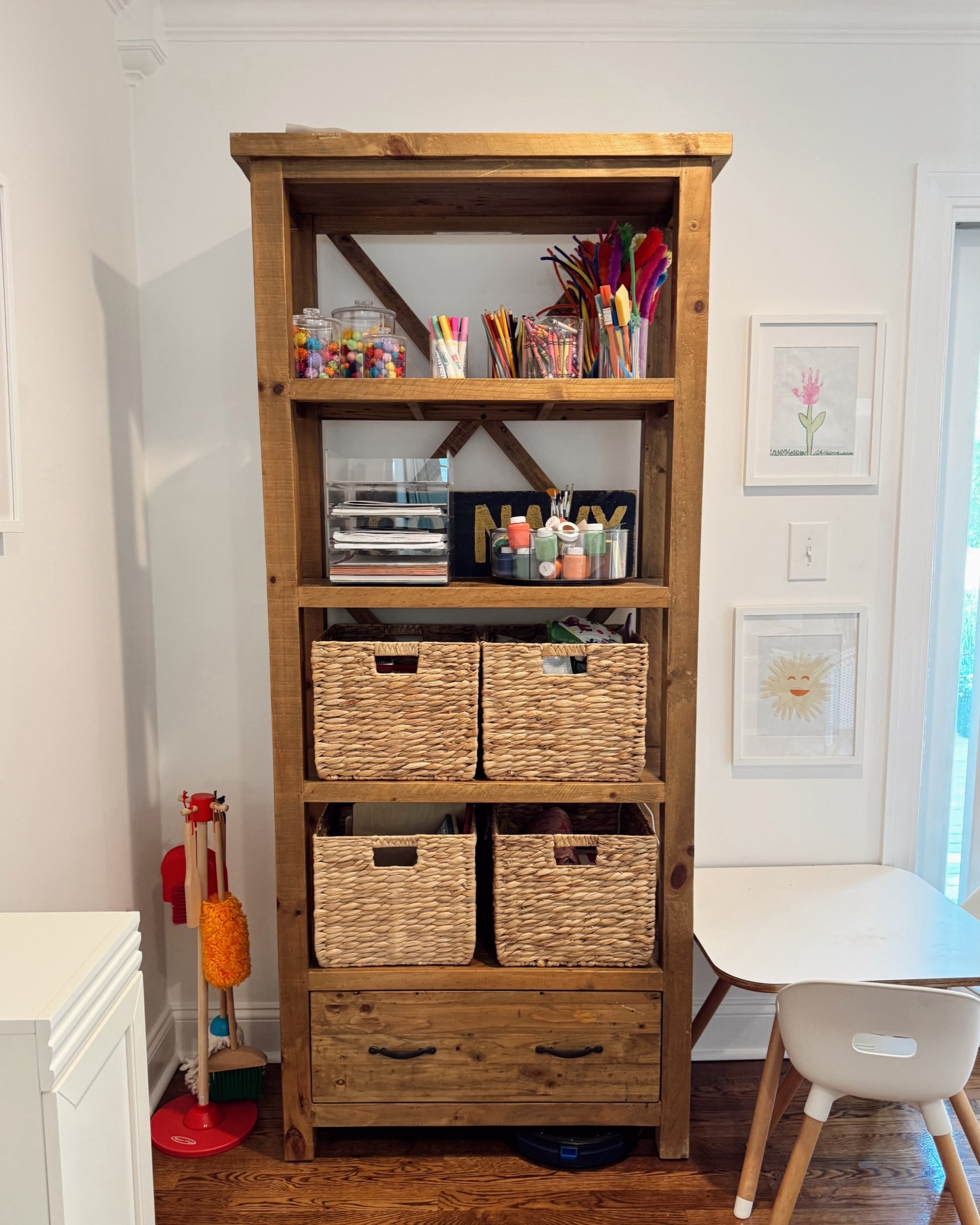 Our little craft corner has quickly become one of the most used spots in the house 🖍️✨ I used woven bins to keep everything accessible but tidy, and added clear jars up top for colorful supplies we reach for all the time. The shelf itself is such a great find for toy or craft storage — linking similar pieces + favorites from this space!

#LTKFamily #LTKKids #LTKHome