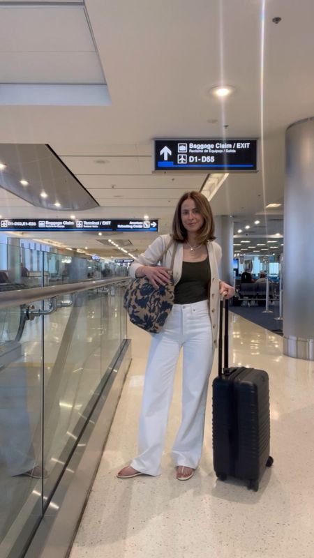 Casual outfit of the day for a flight!

Loving these white wide leg jeans from Citizens of Humanity. Took my normal size for a loose, relaxed fit
Tank is old Zara
Cardigan Everlane
Sandals reformation 
Tote bag Sezane 

#LTKstyletip #LTKtravel #LTKshoecrush
