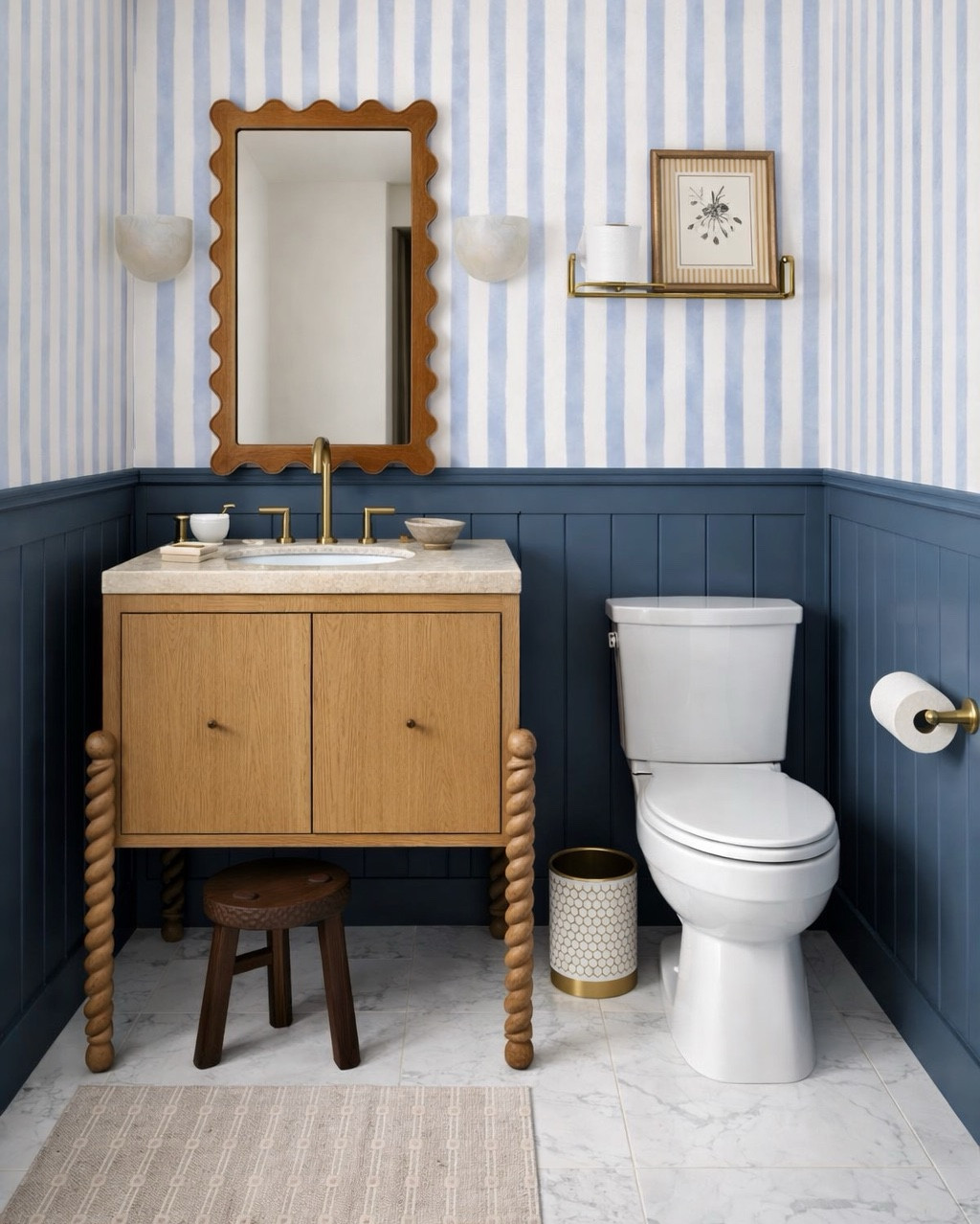 Beautiful half bathroom. Love the striped wallpaper from Lulu & Georgia, and this vanity is gorgeous. The beautiful wavy mirror is on sale. Sconces from Pottery Barn. #halfbathroom #homedecor 

#LTKSeasonal #LTKSaleAlert #LTKHome