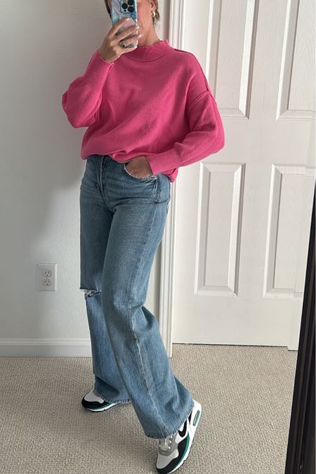 Pink sweater for Valentine’s Day outfit with jeans and sneakers 