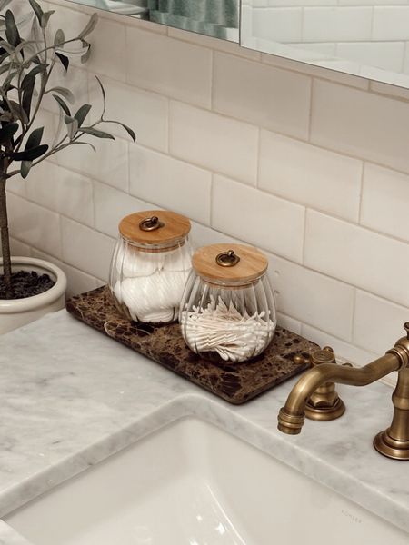 Sometimes the tiniest intentional decisions make all the difference in even the most mundane part of your daily routine! We put our q-tips and cotton rounds in these coffee containers, and it’s an inexpensive choice that makes our bathroom feel that much more intentional. Adding this marble-look tray underneath was the perfect finishing touch! You can get all three for less than $50! 

#LTKfindsunder50 #LTKstyletip #LTKfamily