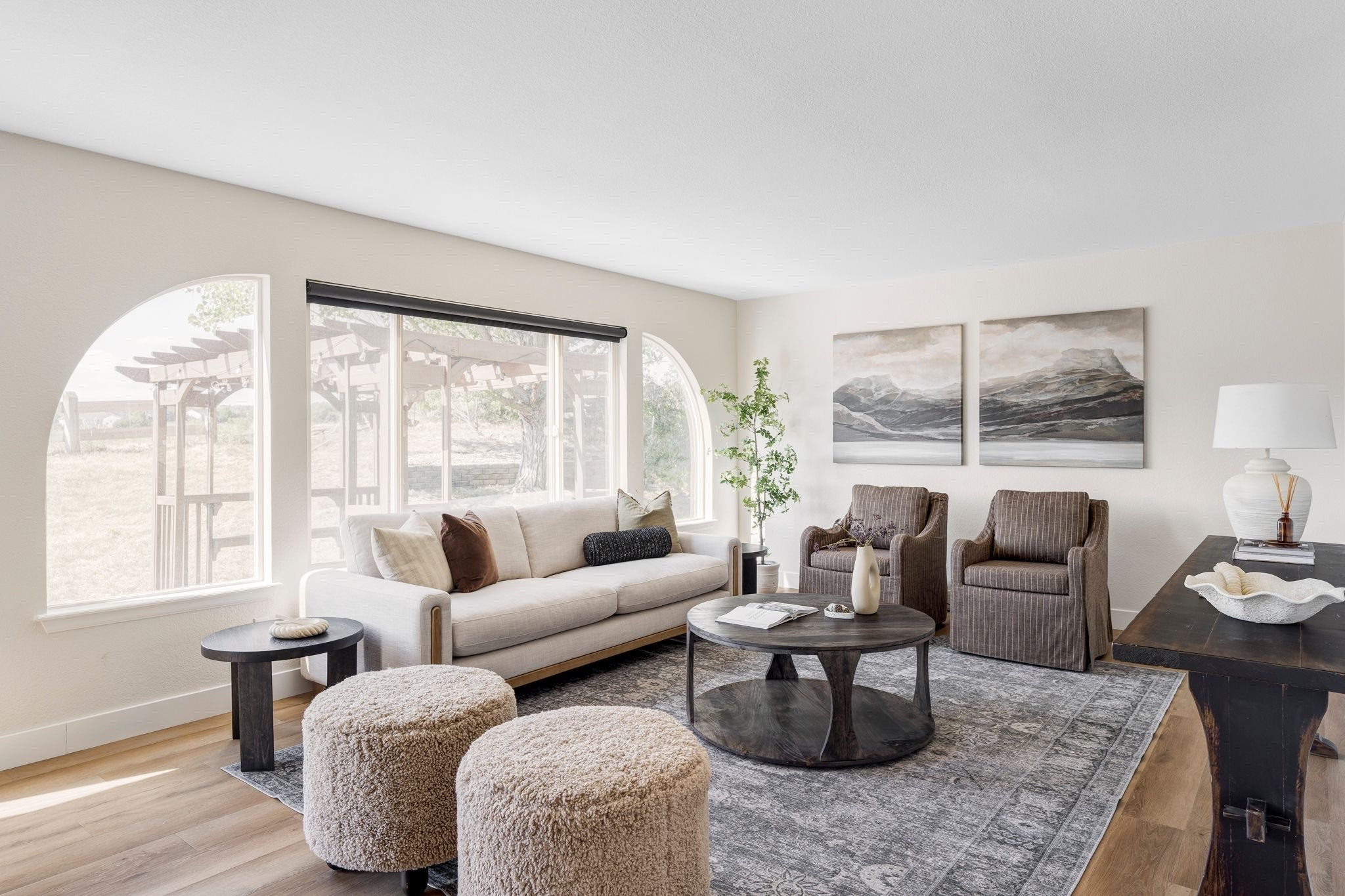Loving this living room with its pinstripe upholstered chairs, wood-framed sofa, and cozy neutral ottomans. 🤍 

Living room, accent chairs, sofa, ottoman, McGee and co, amber interiors, neutral

#LTKHome