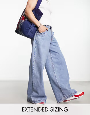 ASOS DESIGN extreme wide leg jeans with red contrast stitch in blue wash | ASOS (Global)