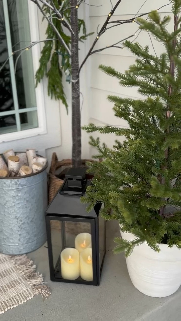 Holiday front porch styling! These faux spruce trees are gorgeous and perfect for styling indoors or outdoors! I love these lanterns for year round styling, and I added the prettiest magnolia and eucalyptus berry wreath! 

#LTKHome #LTKHoliday #LTKStyleTip