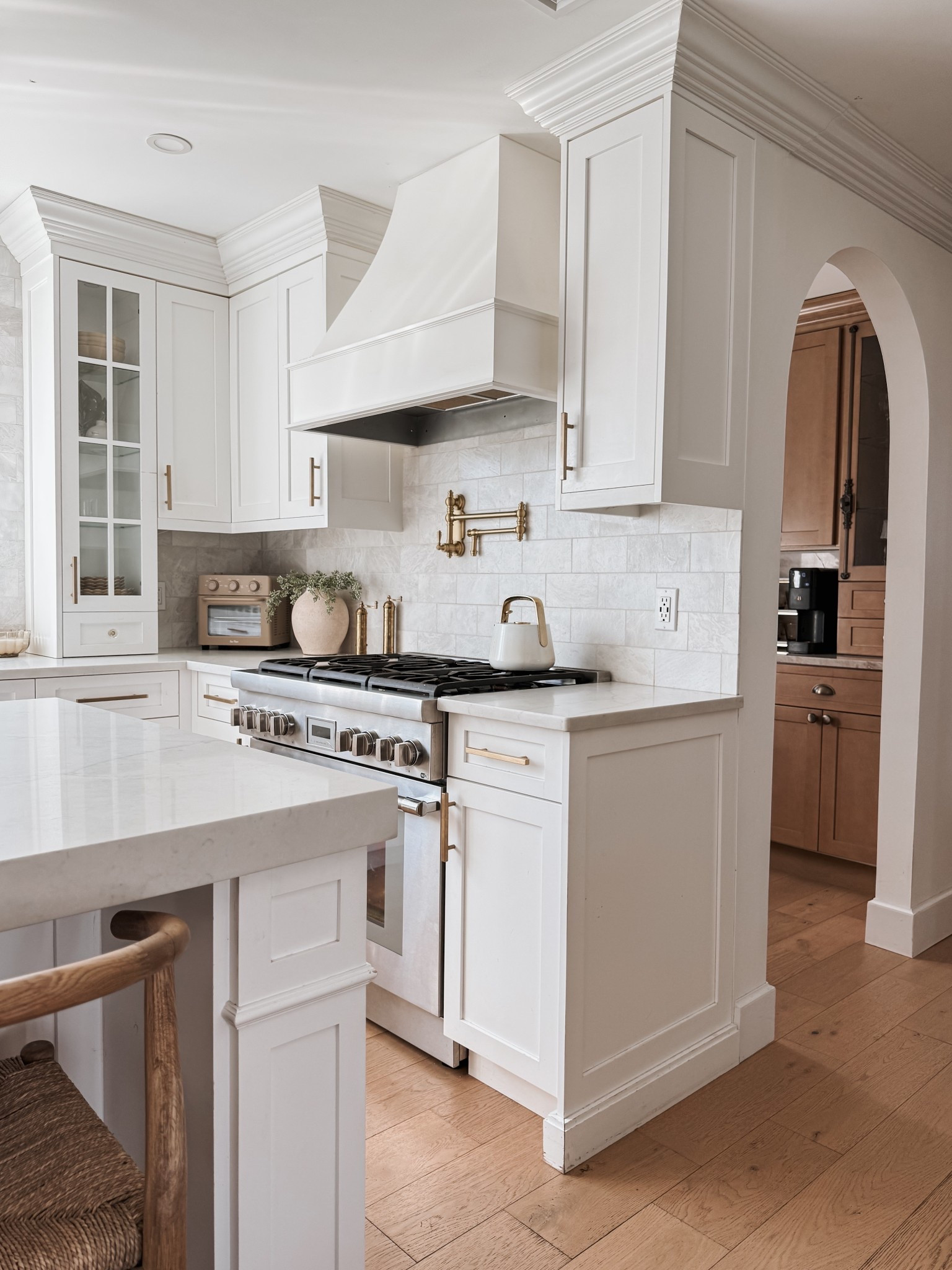 Kitchen decor, pot filler, tea kettle, toaster oven + air fryer, brass salt & pepper mills, vase, artificial greenery, marble tile backsplash. 

#LTKHome #LTKStyleTip #LTKSaleAlert