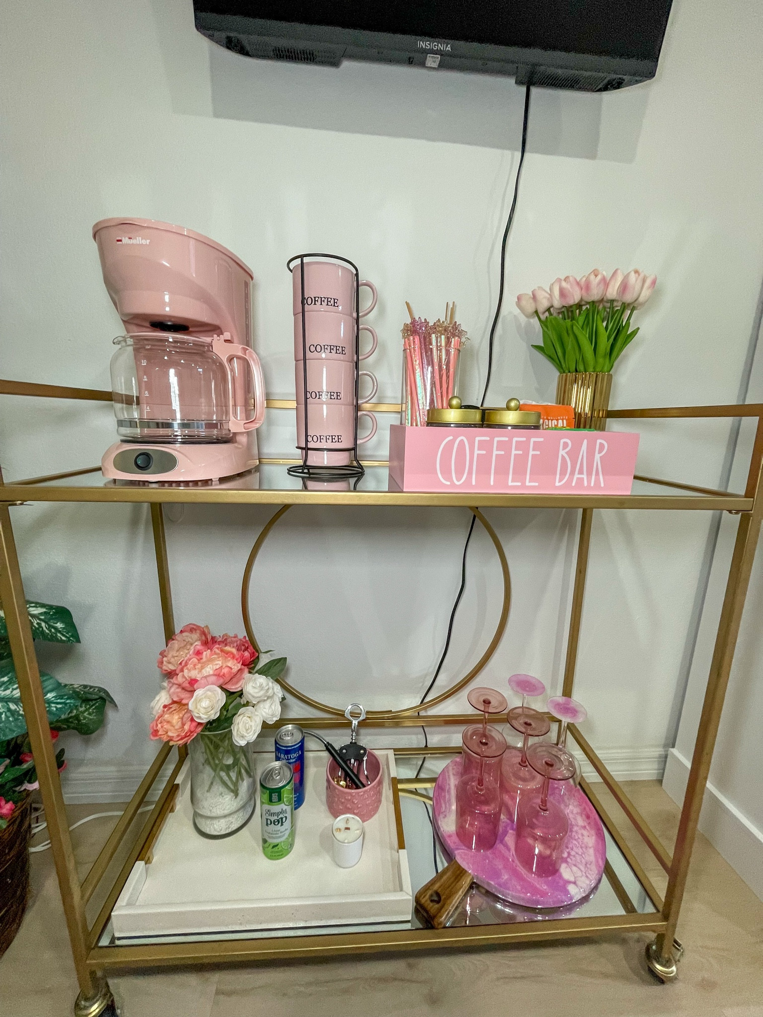 A dreamy pink coffee station stocked and ready for guests.