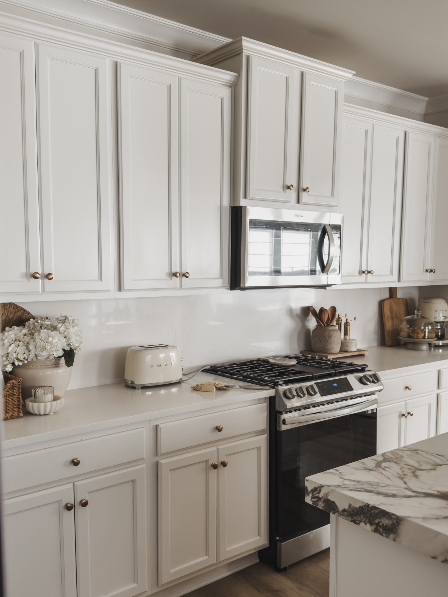 Sharing my kitchen style inspo — featuring aesthetic but functional finds that are used daily. Loving this catch all basket that holds recipe books and our daily mail, the prettiest oil dispenser, a one of a kind vessel that I use for utensils and a cake stand that holds our daily baked goods 🫶🏼 

Kitchen details, spring style, home inspo, details in my home, smeg appliances, McGee and co, shop the look! 

#LTKSeasonal #LTKHome
