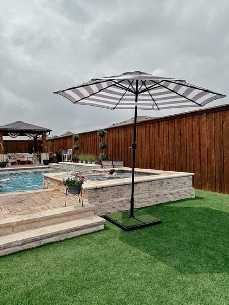 Backyard favorite! Striped solar powered light up umbrella. #outdoorfurniture #backyard #patioumbrella
