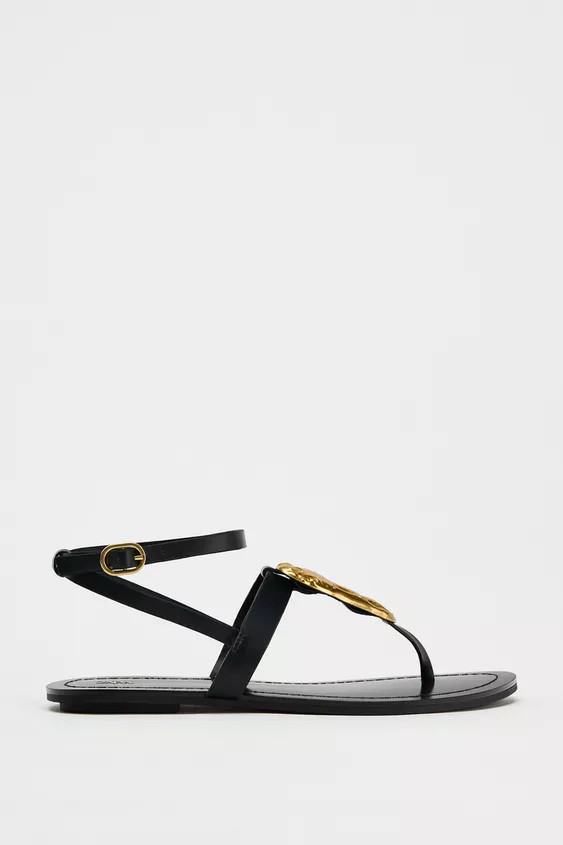 Flat sandals with a metal piece. Strap across the front with toe divider. Metal buckle fastening.... | Zara UK
