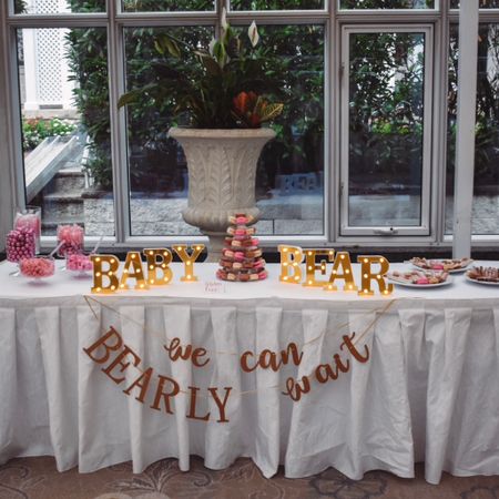 The dessert table at my baby shower. We did lots of pink stuff since it’s a girl—a pink candy bar using plastic jars, a macaron tower I made with cookies from a local baker and a plastic structure, chocolate covered pretzels, a We Can Bearly Wait sign, and light up letters spelling out BABY BEAR for decoration. 

#LTKbump #LTKbaby #LTKparties