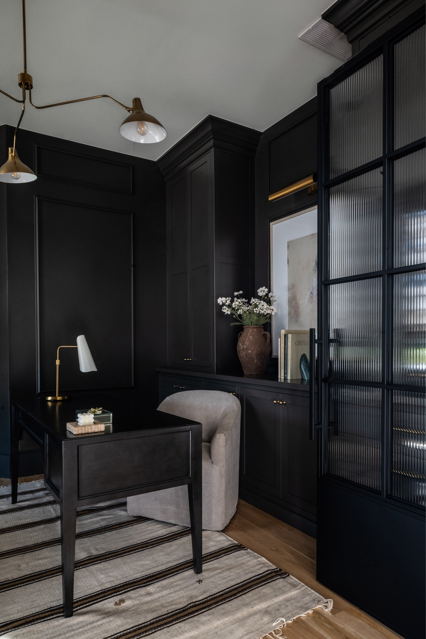 Dark black moody office with black office desk, grey office chair, brass lighting, kilim rug

#LTKSaleAlert #LTKSeasonal #LTKHome